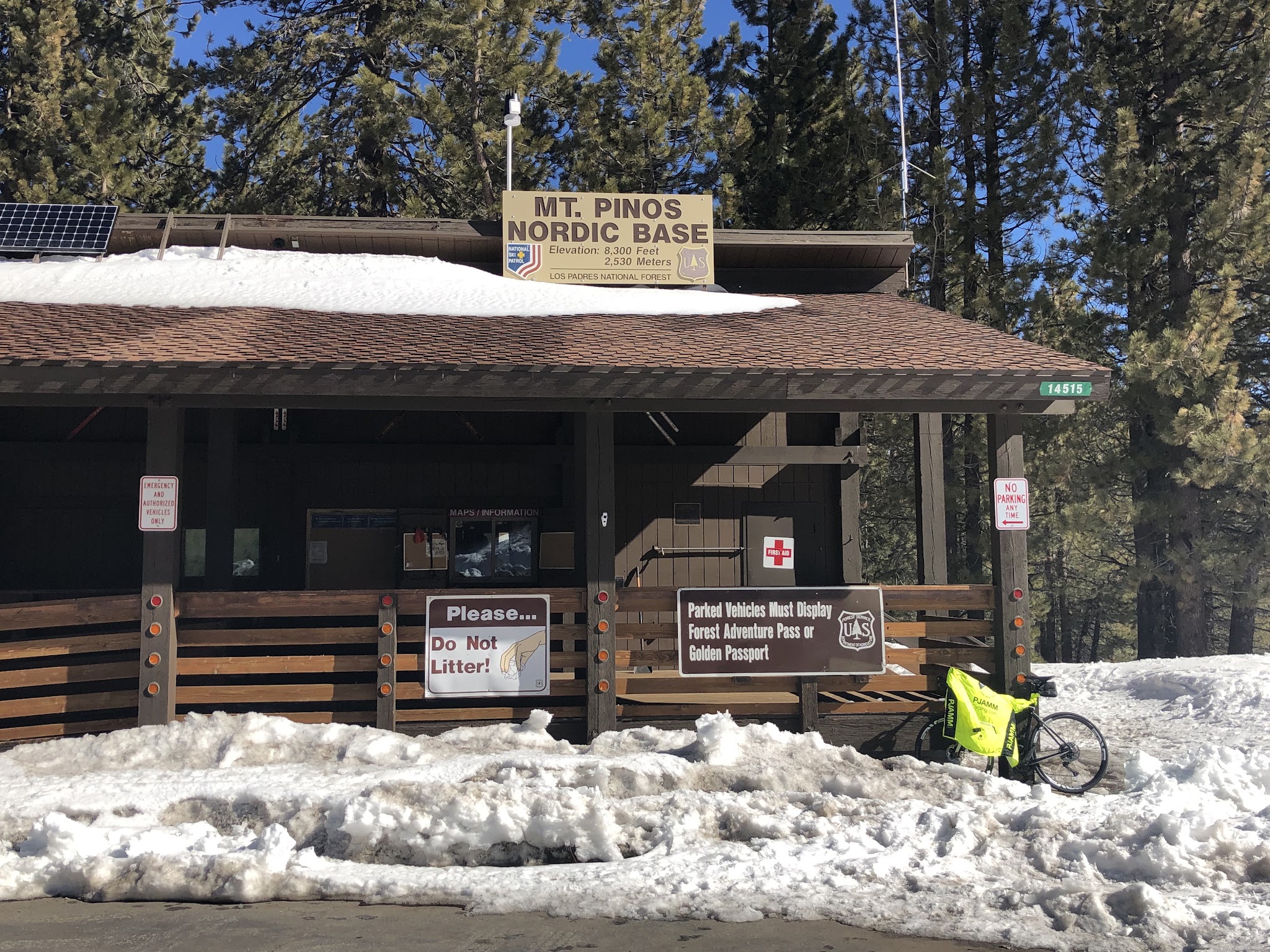 Cycling Mt. Pinos - Mt. Pinos Nordic Center - bike leaning against railing with pjamm cycling jacket