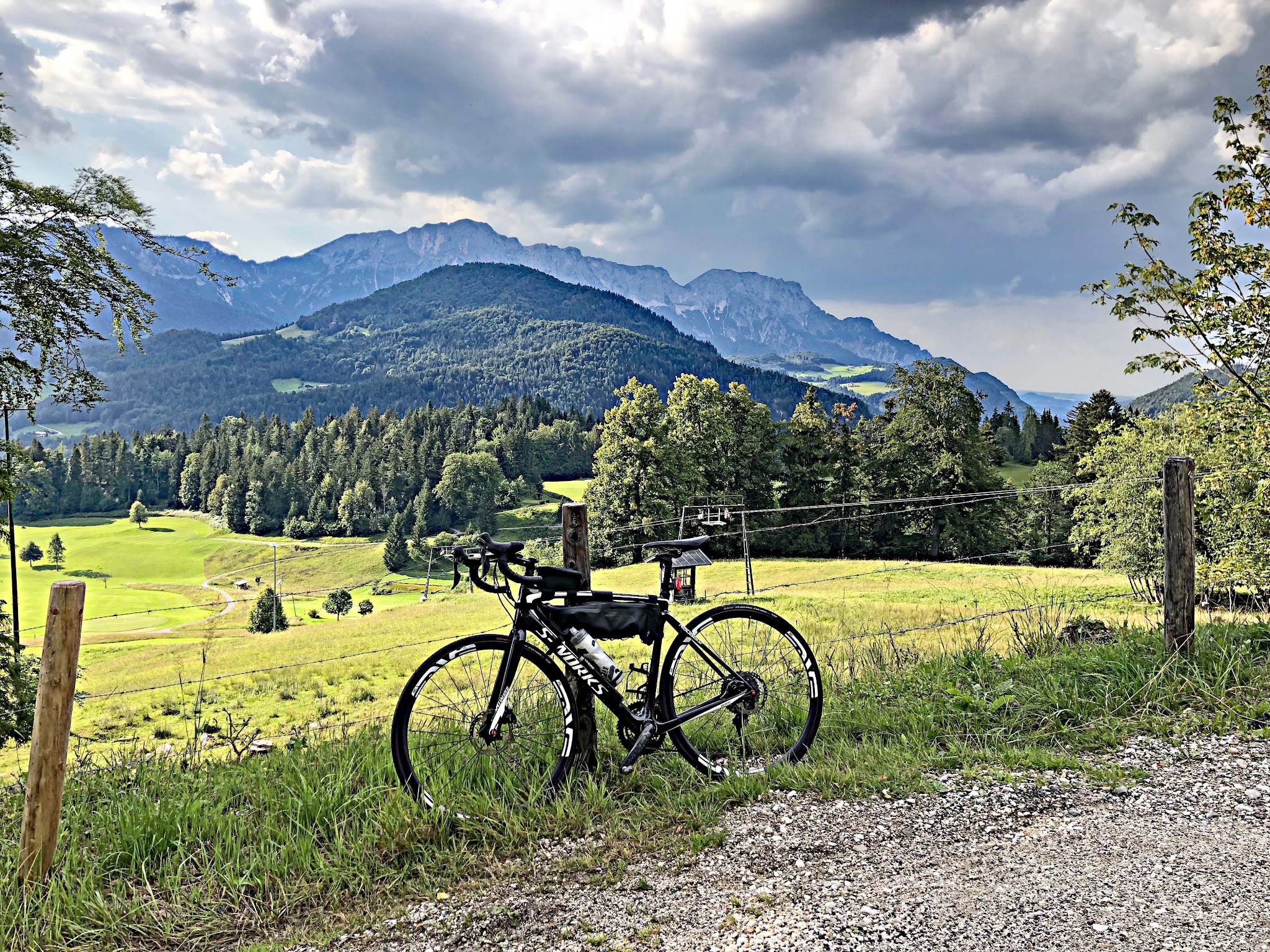 Climbing Kehlsteinhaus - Eagles Nest by bike - bicycle against fence with mountains in background