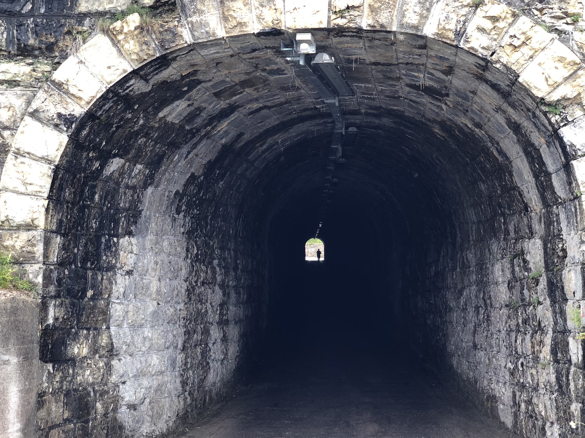 Cycling Monte Zoncolan from Ovaro tunnel with cyclist riding in it. 