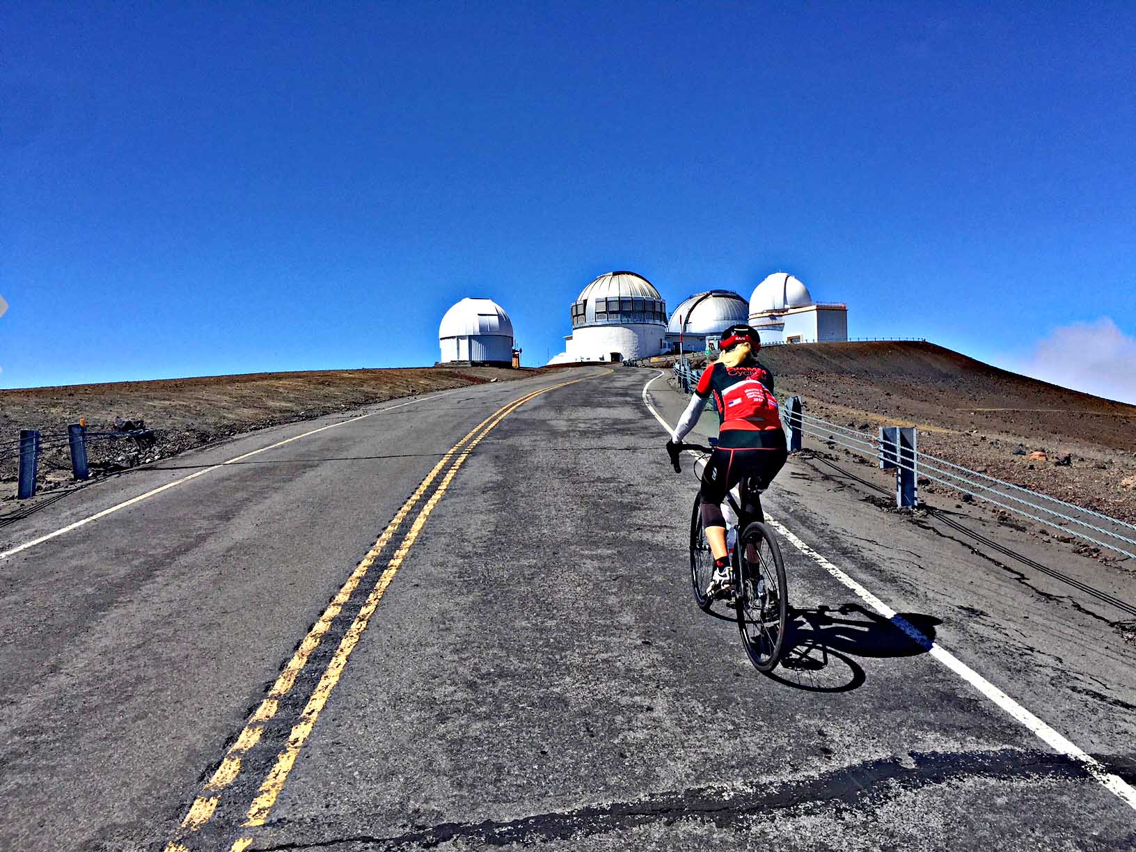 cycling Top 10 US Bike Climbs - Mauna Kea cyclist coming above the clouds