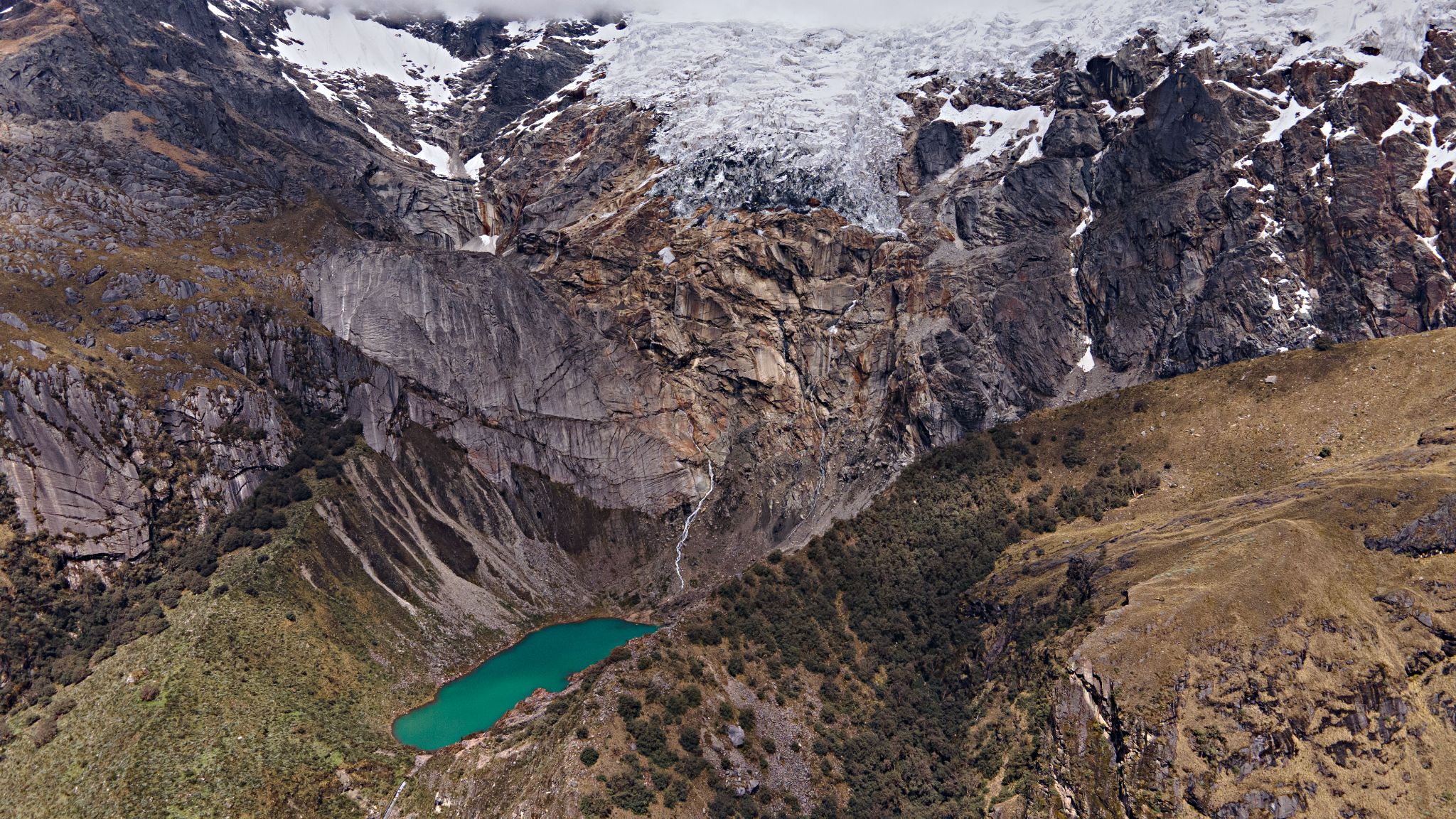 Cycling Punta Olimpica East, Peru - aerial view of bright blue glacial lake, Laguna Huallcococha