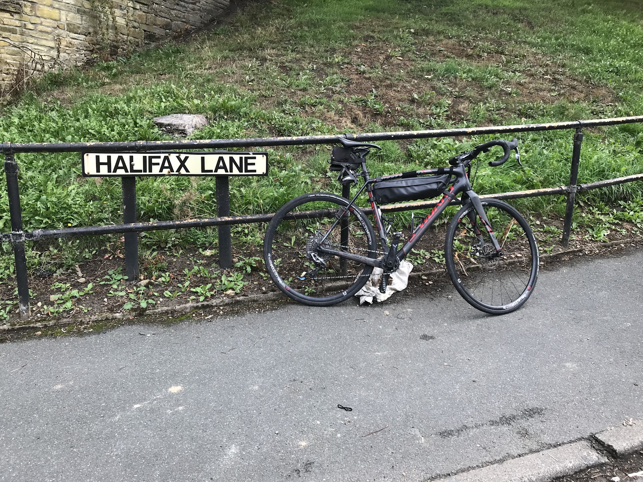 Bike climb Halifax Lane - Simon Warren #44 Greatest Cycling Challenge, Britain  - bike leaning against Halifax Lane street sign