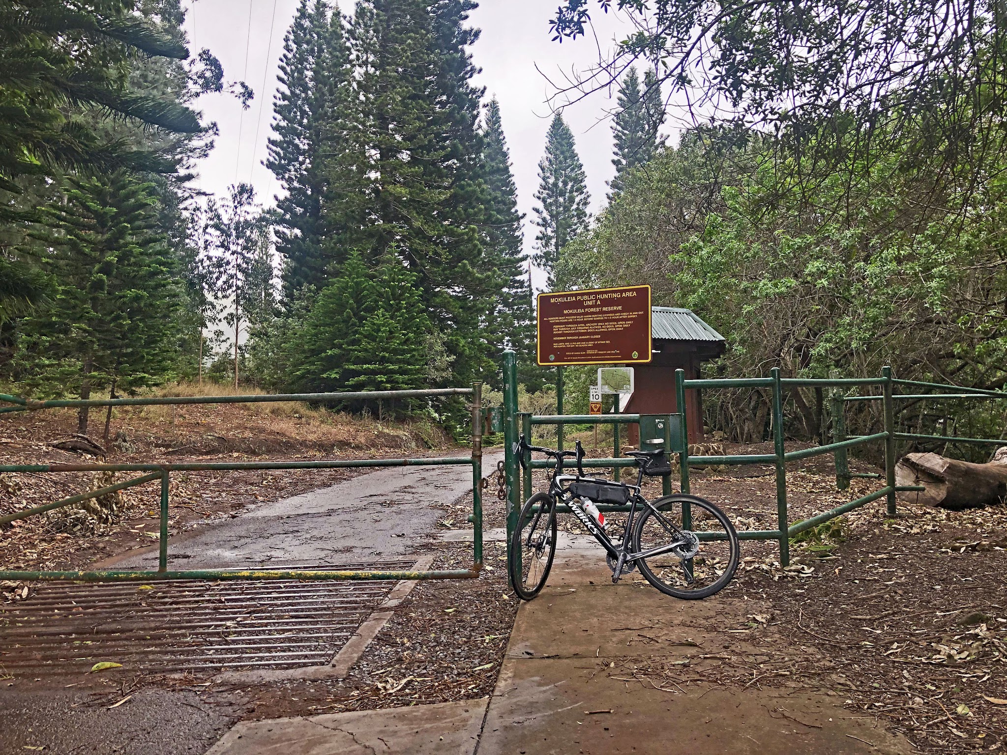 Cycling Mokuleia Forest Reserve Road - finish - gate with bike