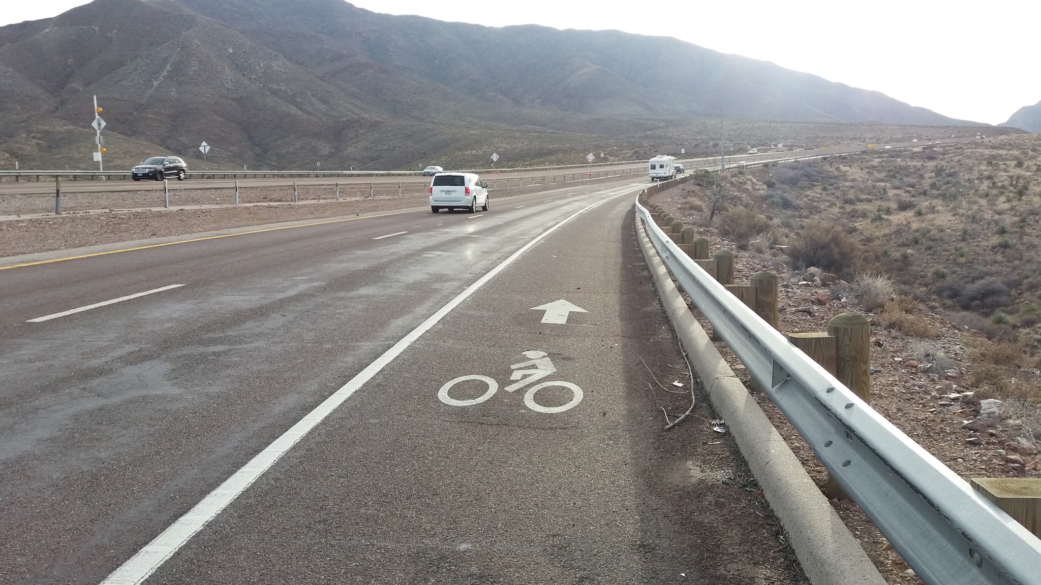 Climbing Smugglers Pass - Transmountain Drive by bike - roadway and bike alert road paint