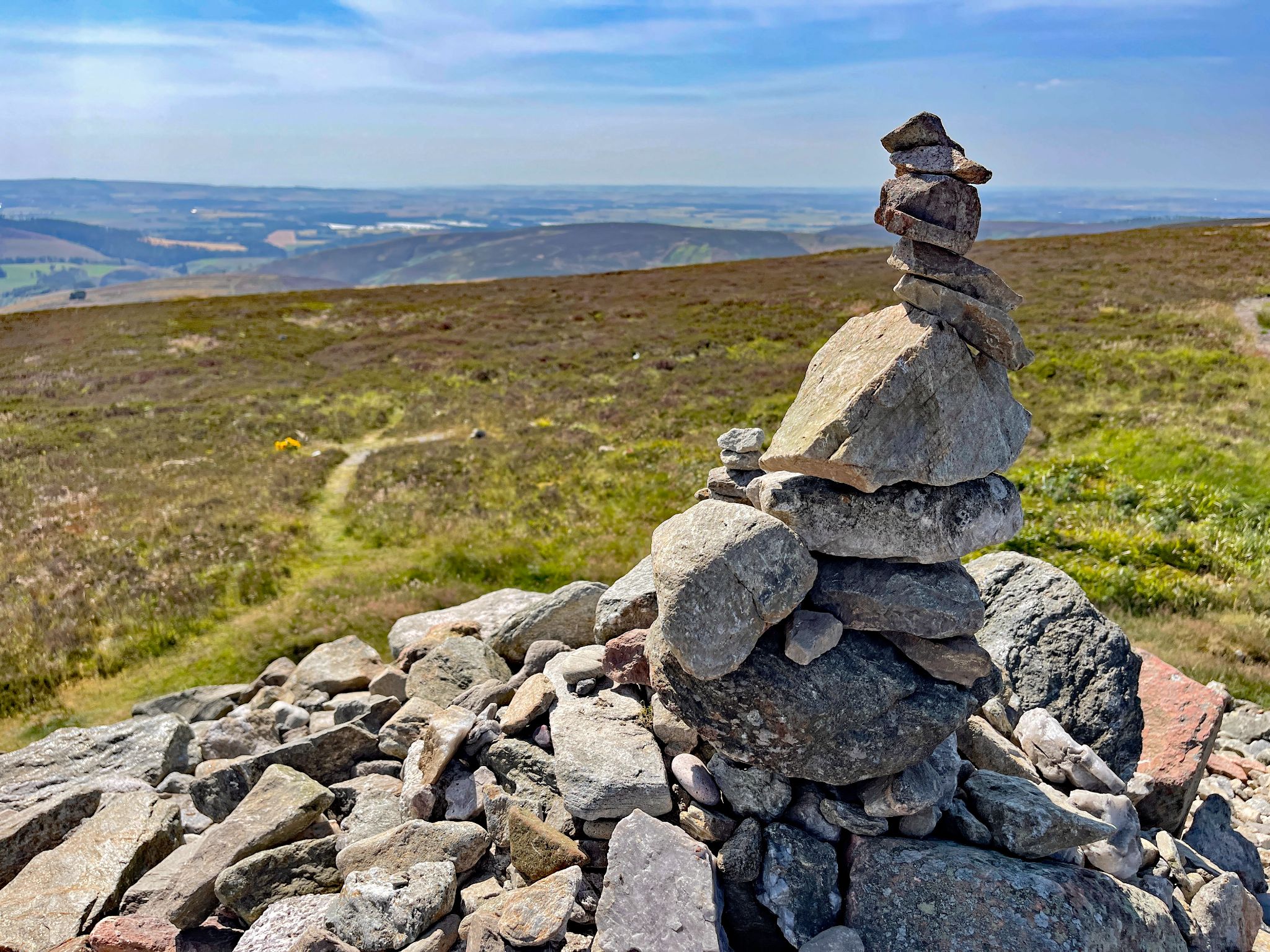 old stone cairn at climb summit dating back to 2000 BC