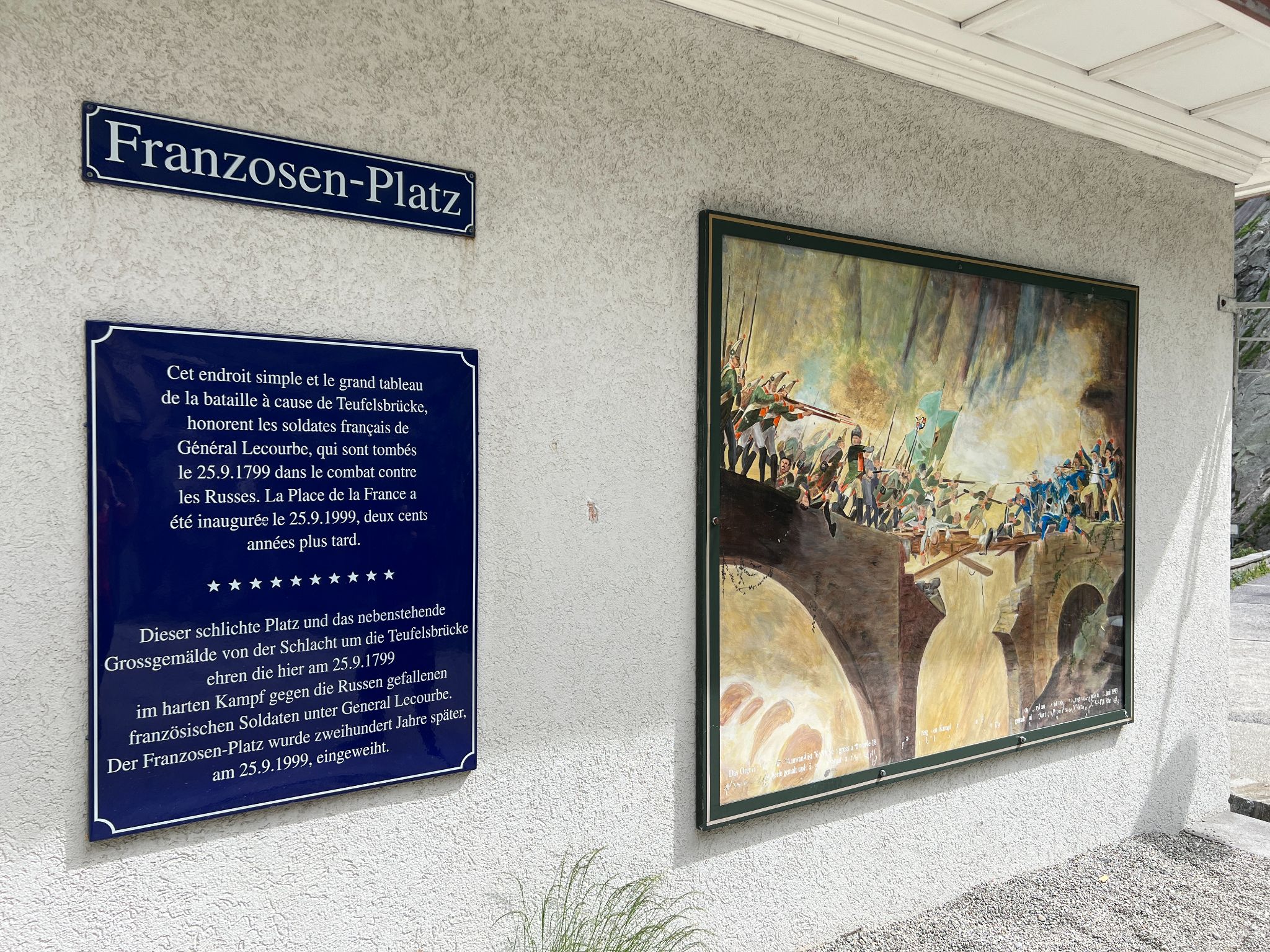 informational signs in German with information on the building and lore of Devil's Bridge; artist's rendition of the bridge's construction 