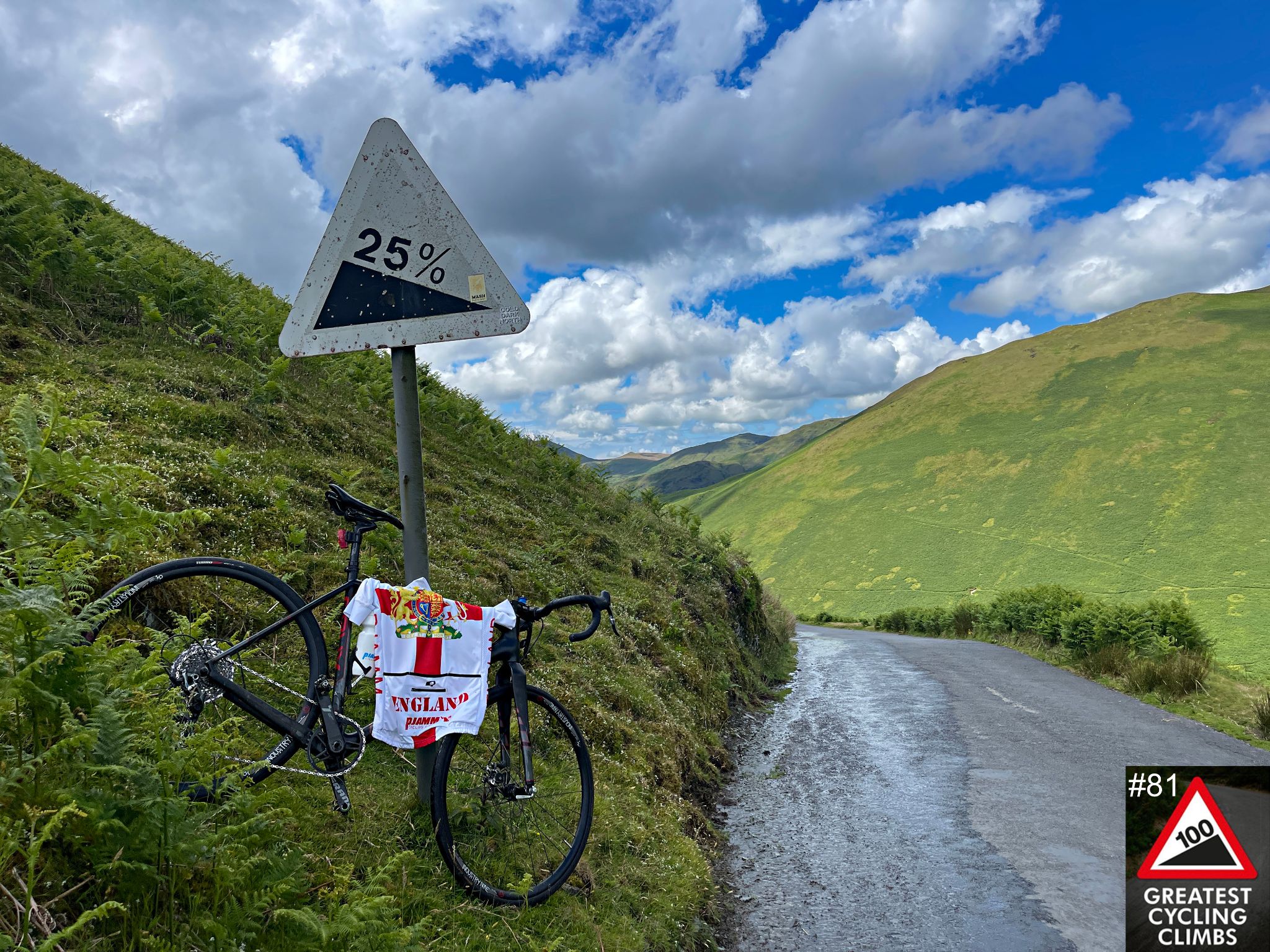 bike parked on side of the road against road sign for 25% grade