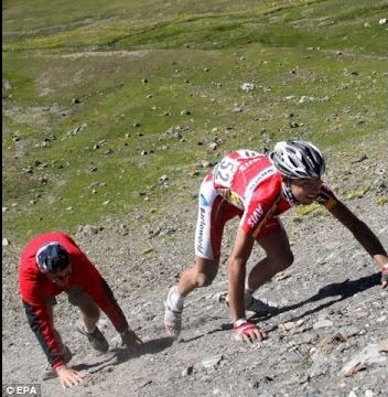 Cycling Cime Bonette from Jausiers, France - Augustyn climbs back up hillside after falling during Tour de France