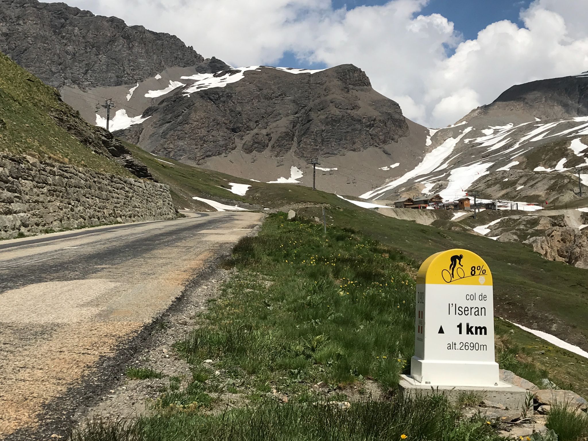 Col de L'Iseran from Bonneval-sur-Arc: yellow and white Tour de France kilometer marker at the climb's finish