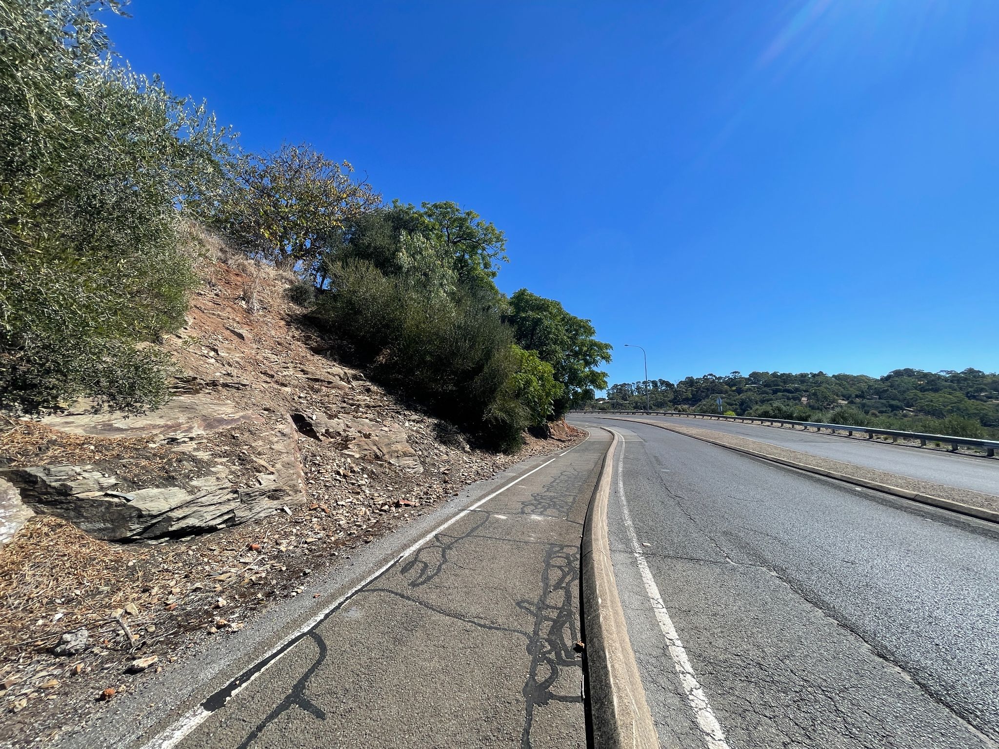 view looking down over two-lane roadway with bike path