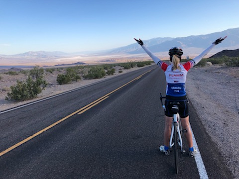Cycling Daylight Pass Death Valley - PJAMM Stacy Topping on road with bike