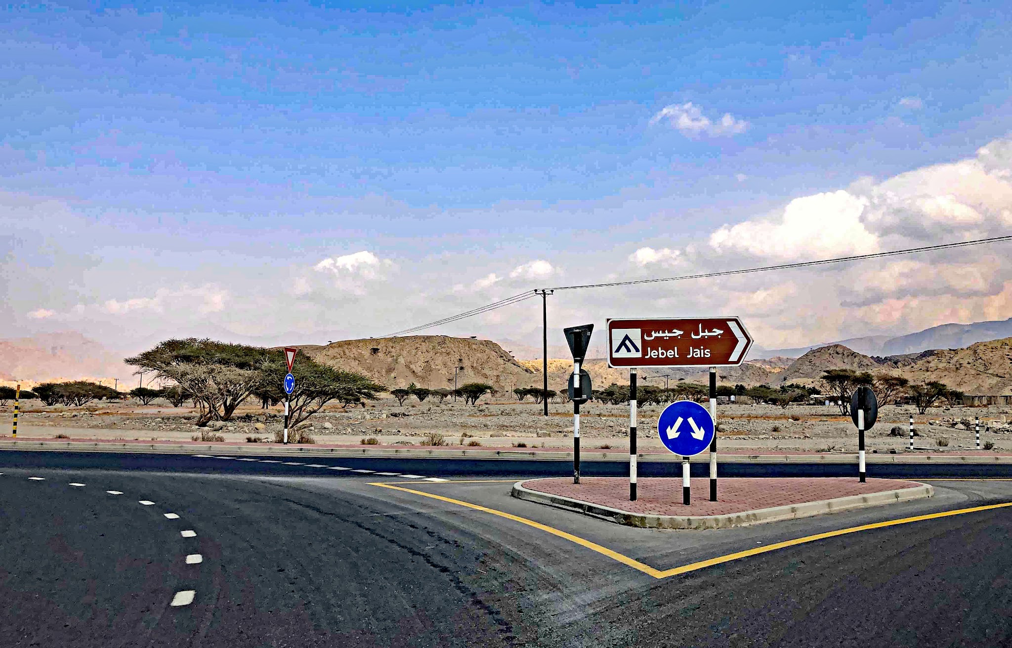 Jebel Jais, Ras Al Khaimah, UAE Jebel Jais, Ras Al Khaimah, UAE - fork in highway with road sign pointing right toward Jebel Jais