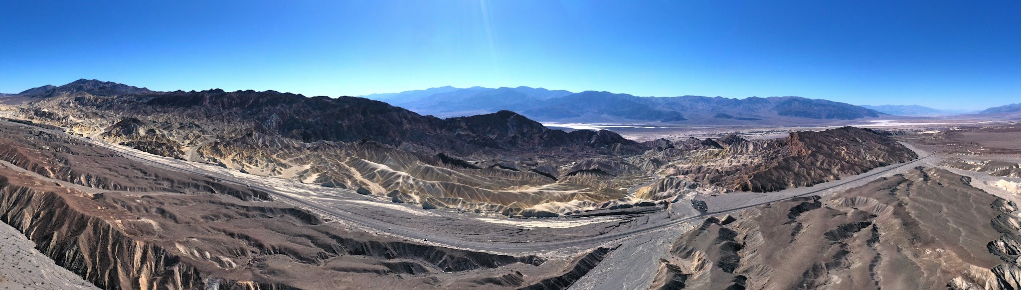 Cycling Death Valley National Park, California Cycling Death Valley National Park, California - panoramic photo including desert landscape, hillsides, and highway roadway