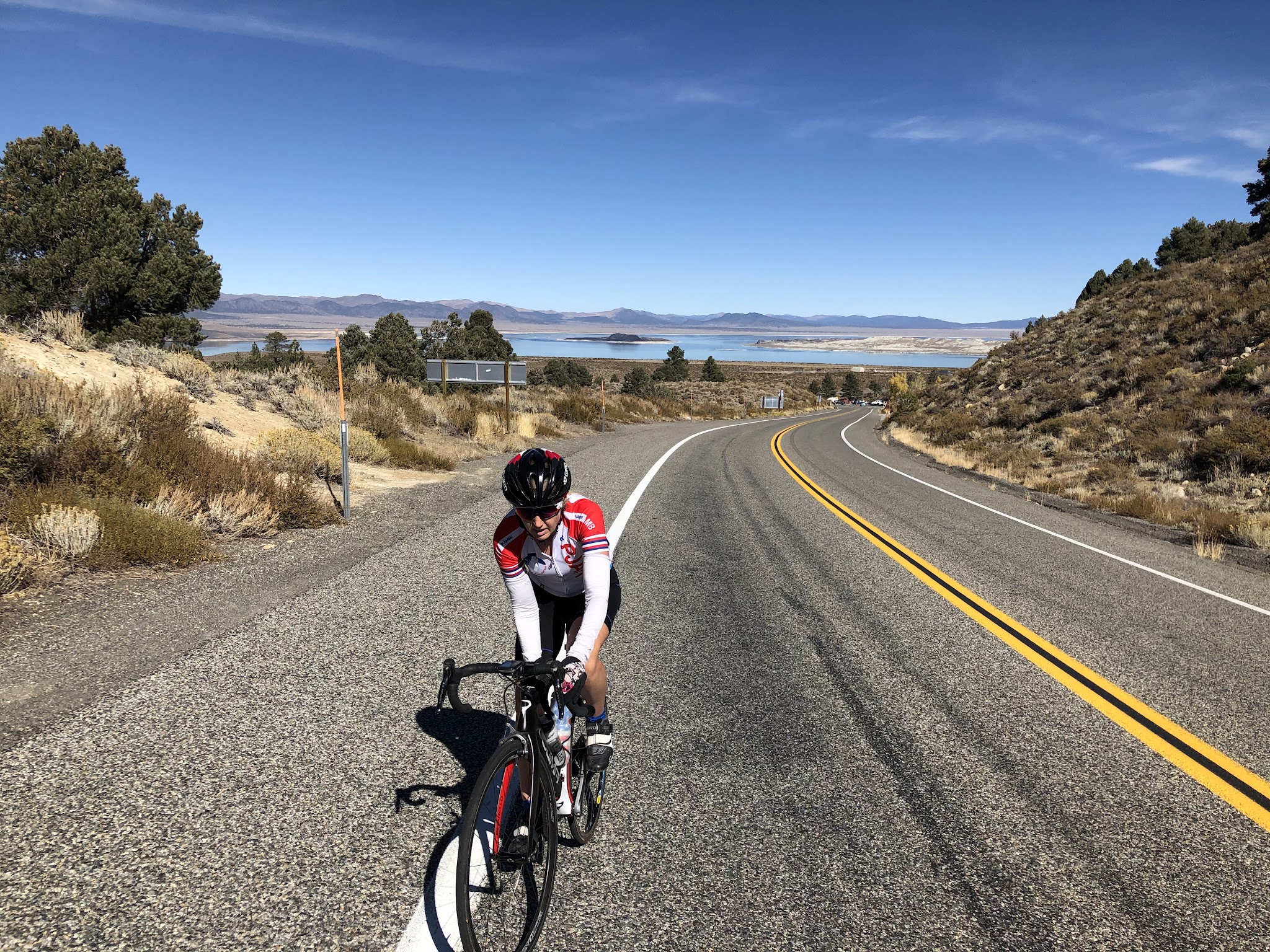 Cyclist on road, Mono Lake in background