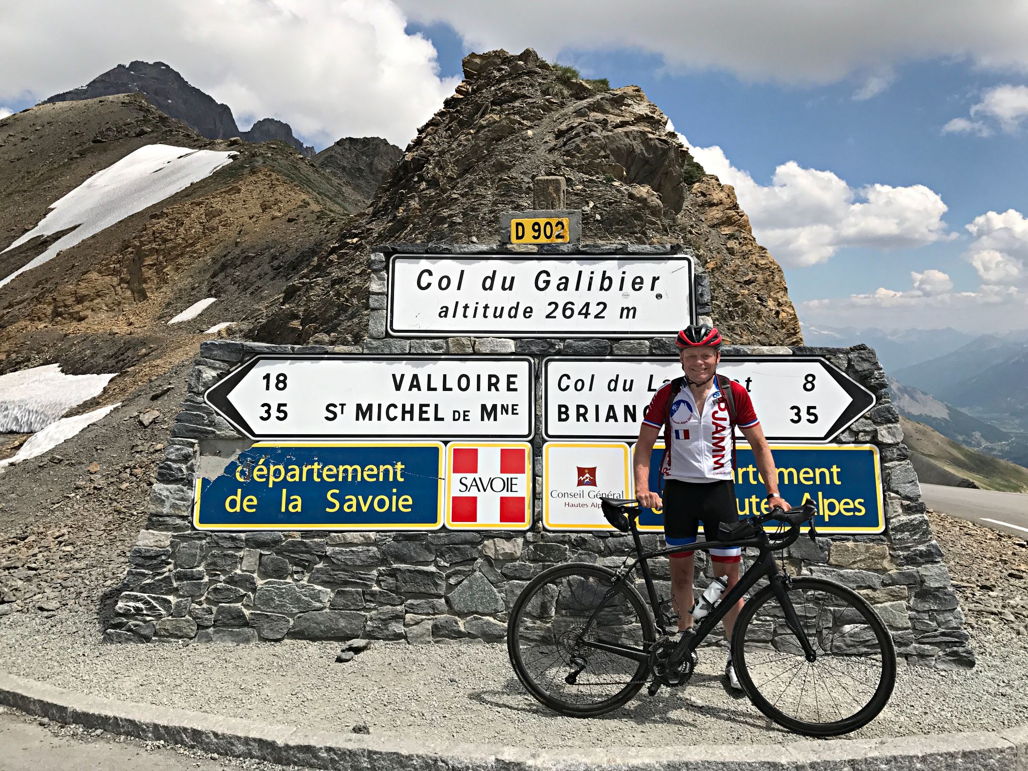 Cycling Col du Télégraphe - PJAMM Cyclist John Johnson poses with bike at mountaintop finish for Col du Galibier