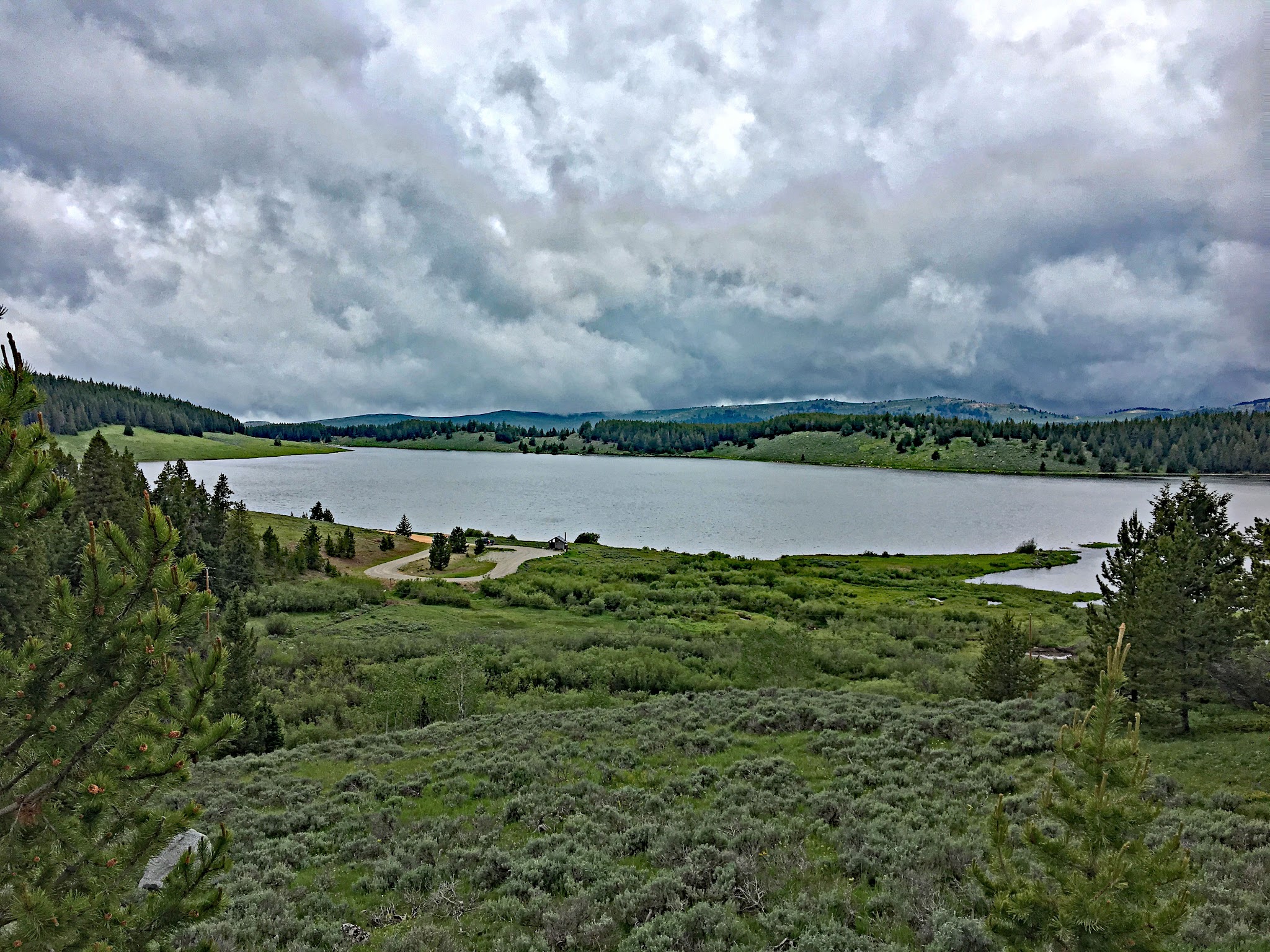 Cycling Powder River, Wyoming - Meadowlark Lake, small lake surrounded by greenery and evergreen trees
