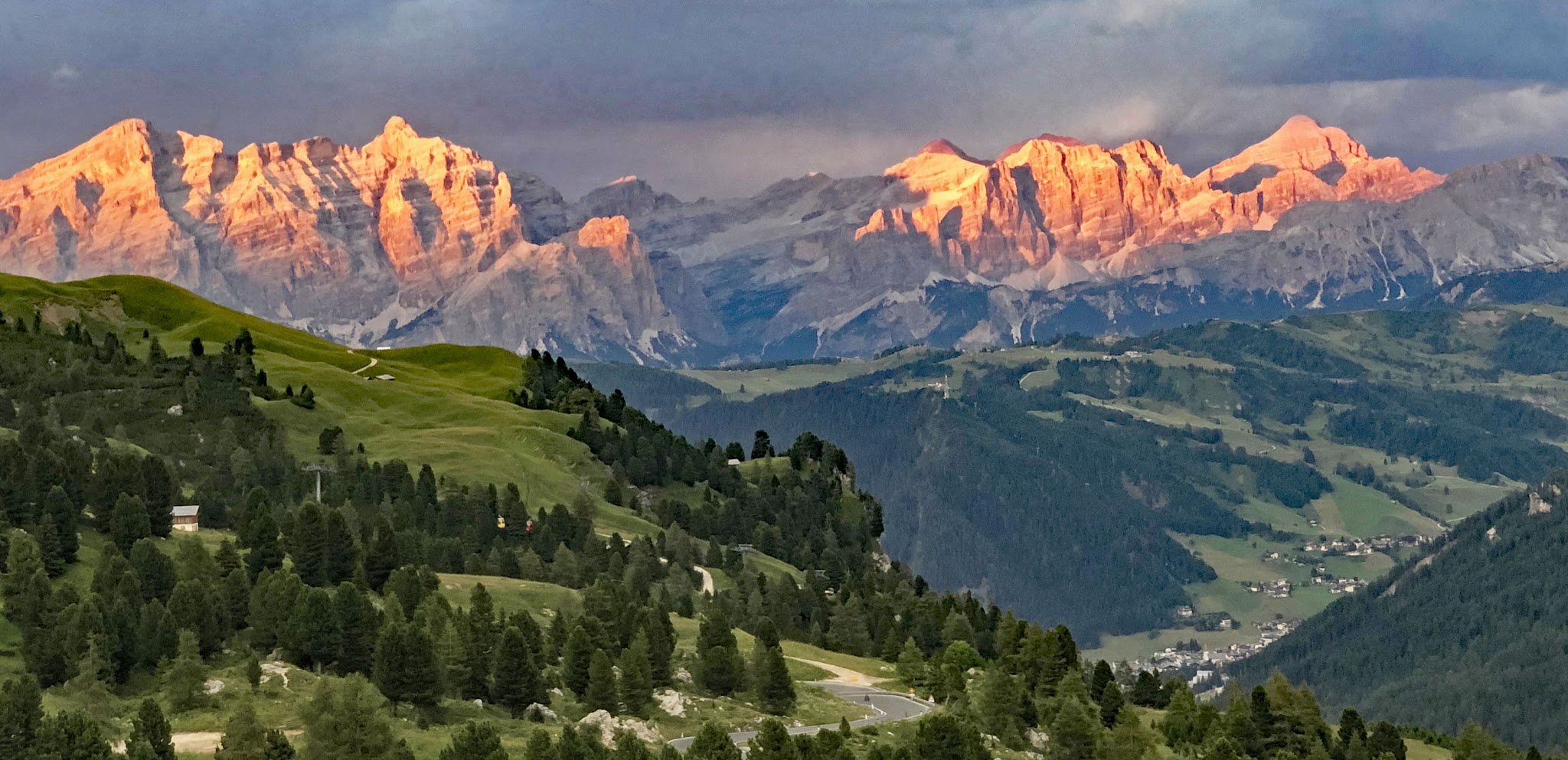 Cycling The most gorgeous bike climbs in the world - Dolomites - Passo Gardena - Mountains at sunset and roadway