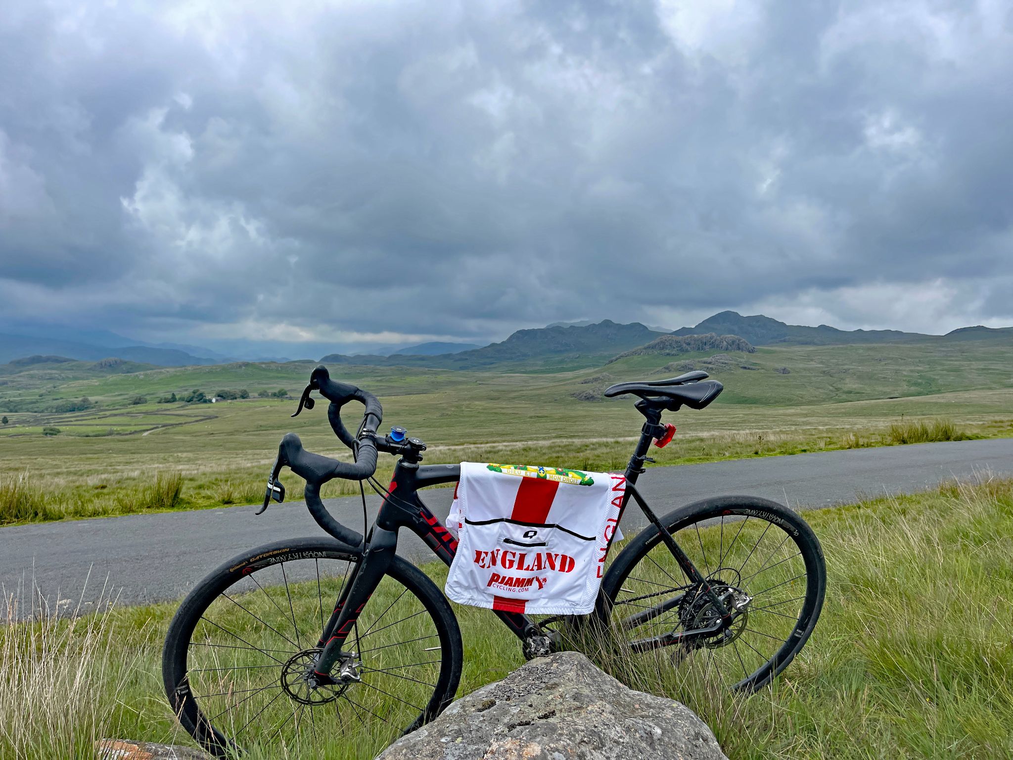 bike parked at unmarked finish next to a rock