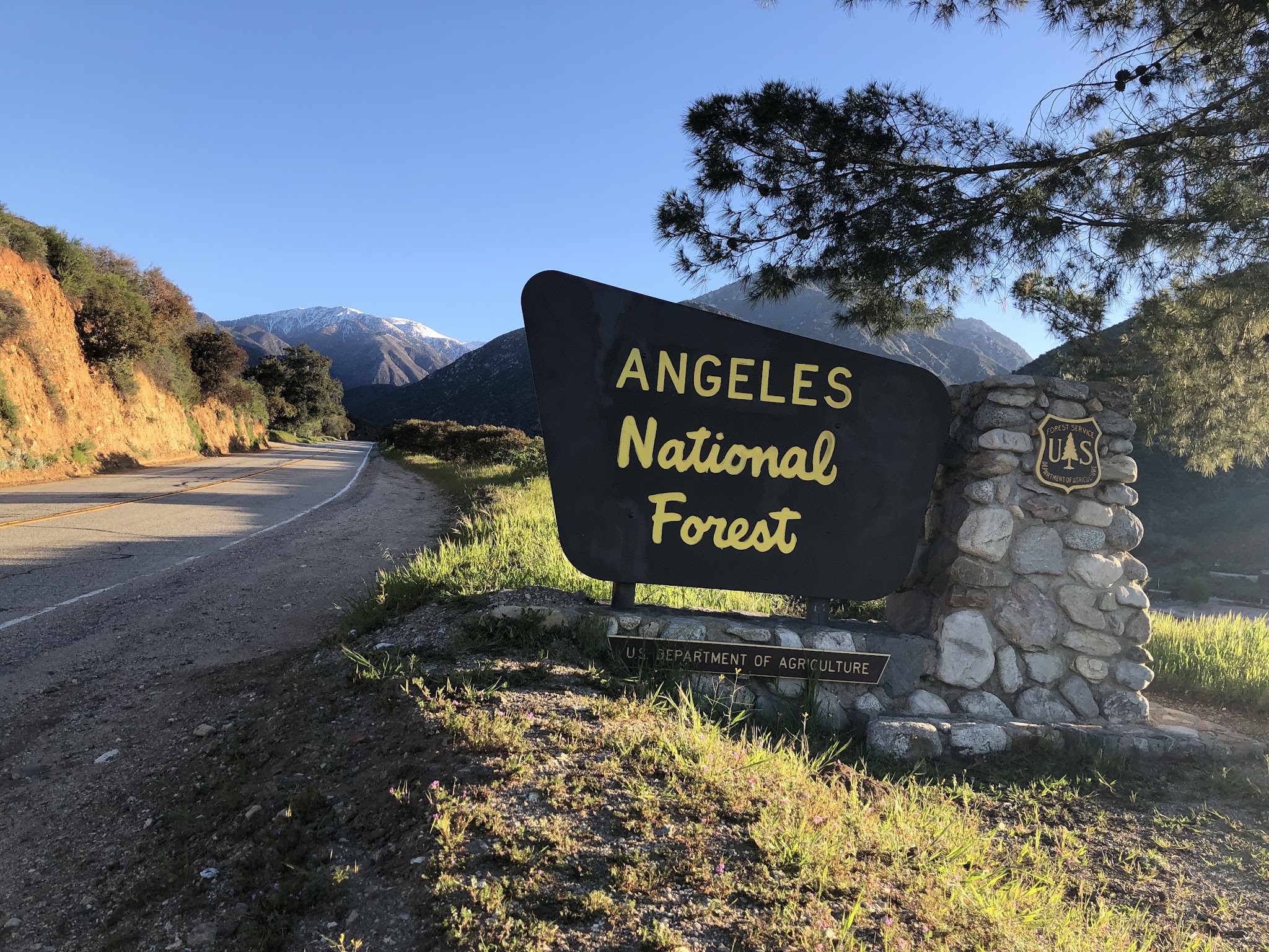 Cycling Mt. Baldy - cyclist on bike riding up to Mt Baldy Resort sign
