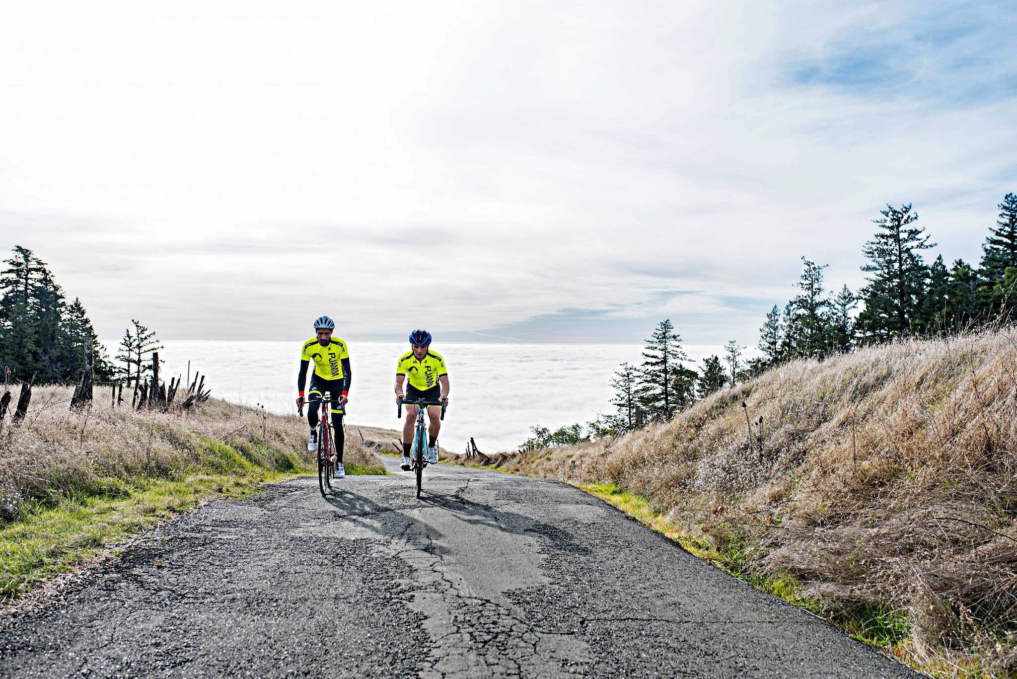 Bike climb Fort Ross Road - 2 cyclists at top of climb