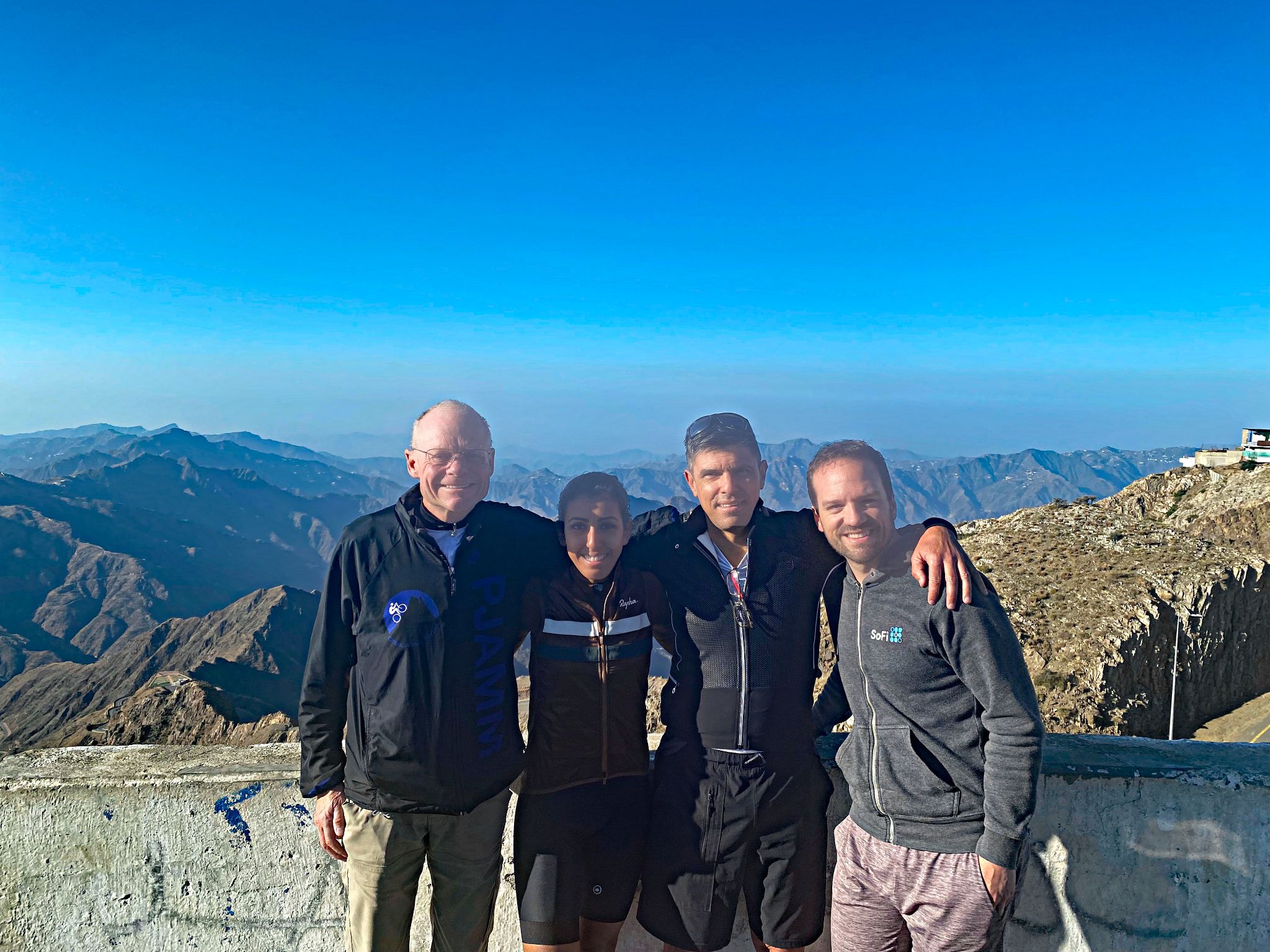 Cycling Mount Souda, Saudi Arabia - John stands with Ahlam Zaid, Christiaan Beyers, and Steven Olyer on top of Mt. Souda