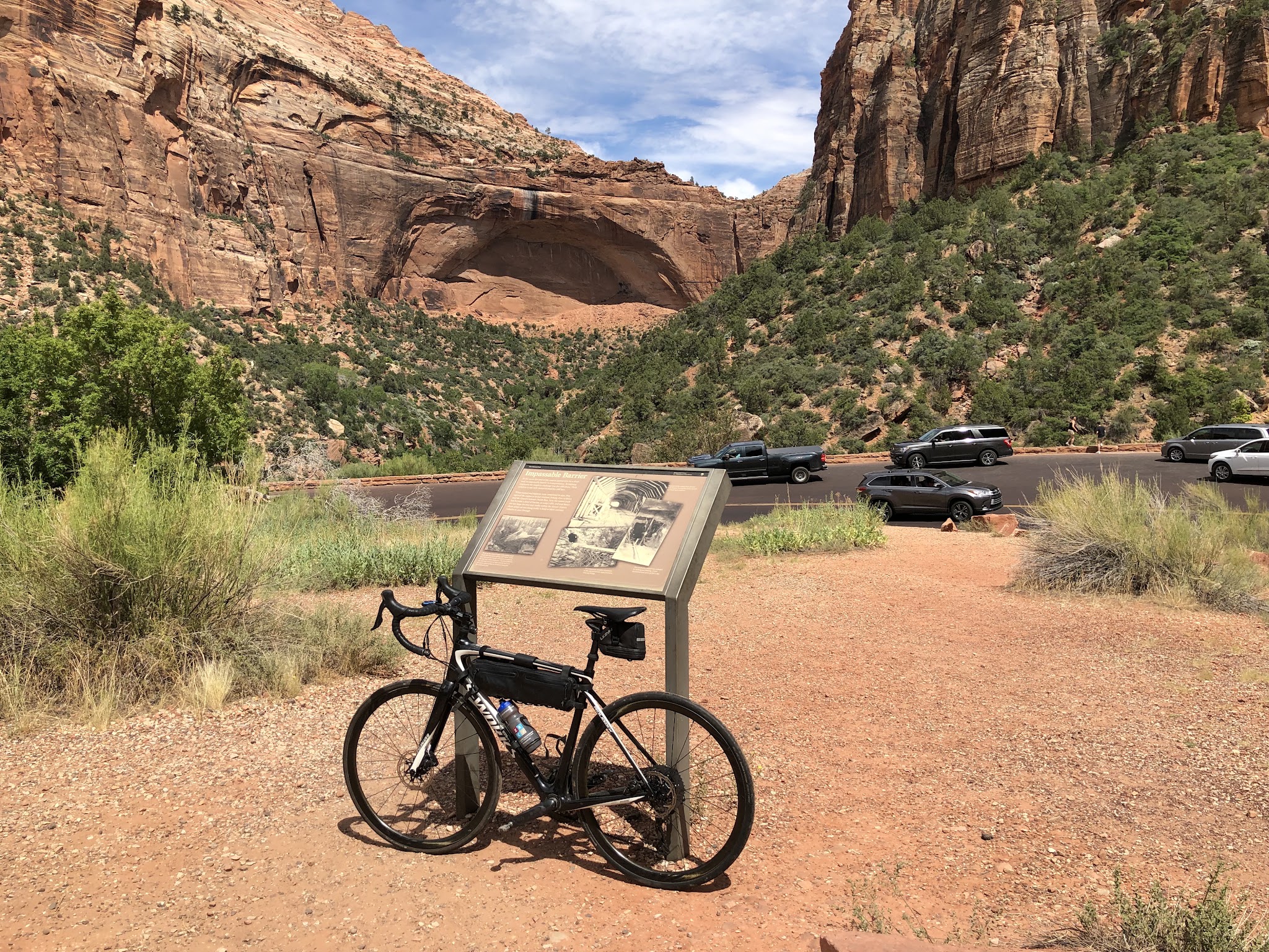 Hwy 9 to Zion Tunnel Cycling Hwy 9 to Zion Tunnel - bike leaning against historical marker with rock structures in background