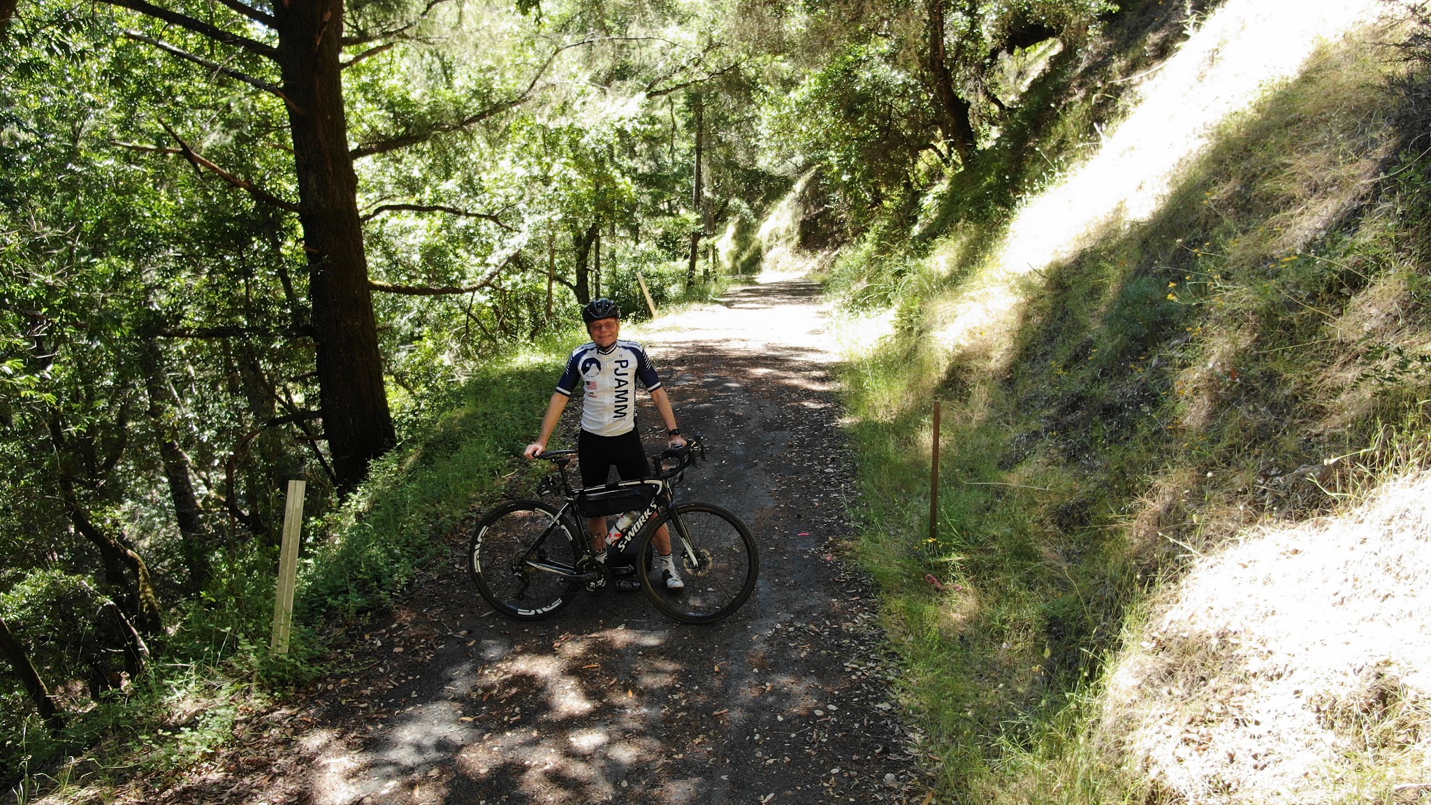 Climbing Old Cazadero Road  by bike - PJAMM Cycling John Johnson with bike at finish