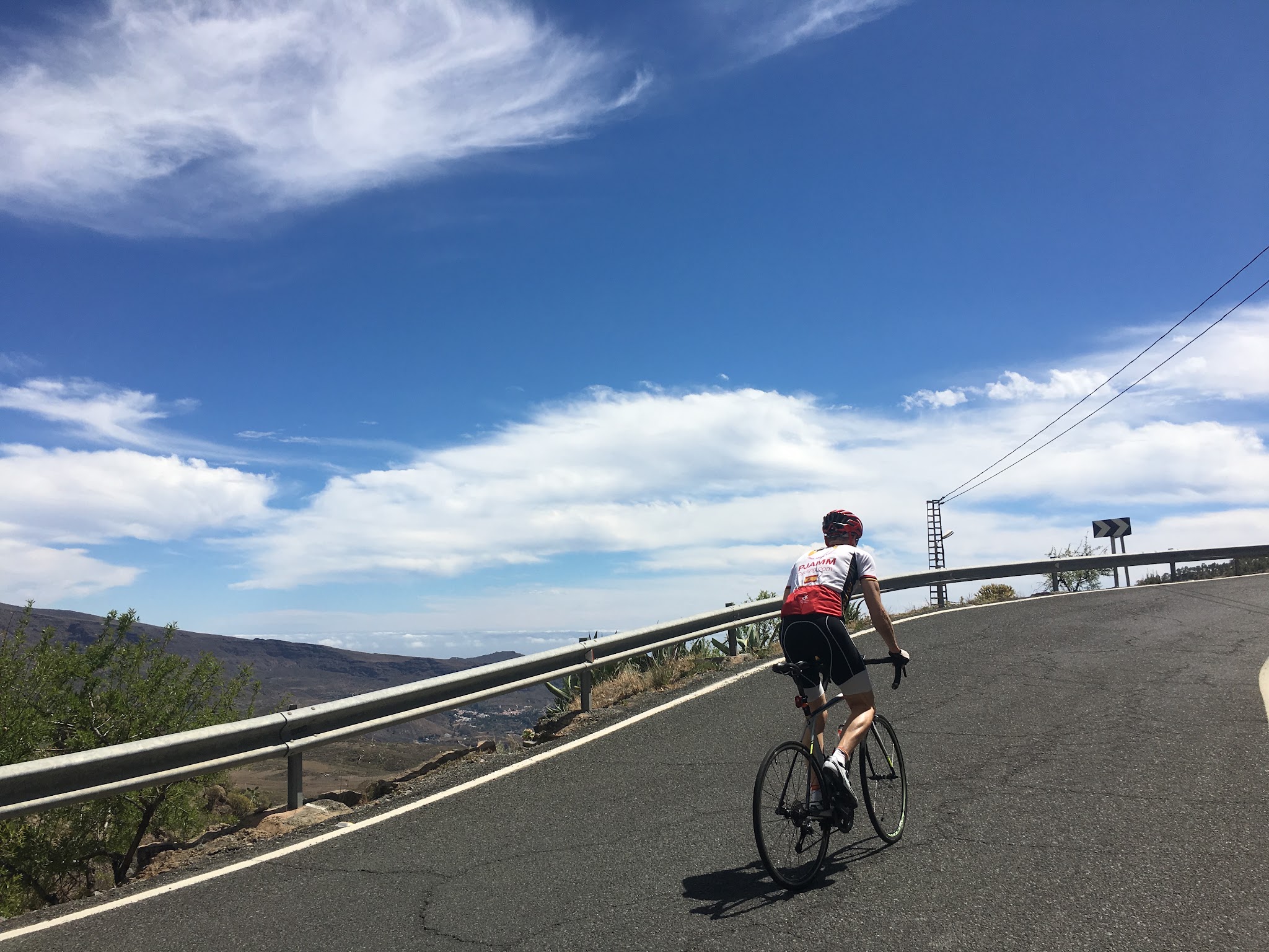 PJAMM cyclist riding along steep segment of roadway