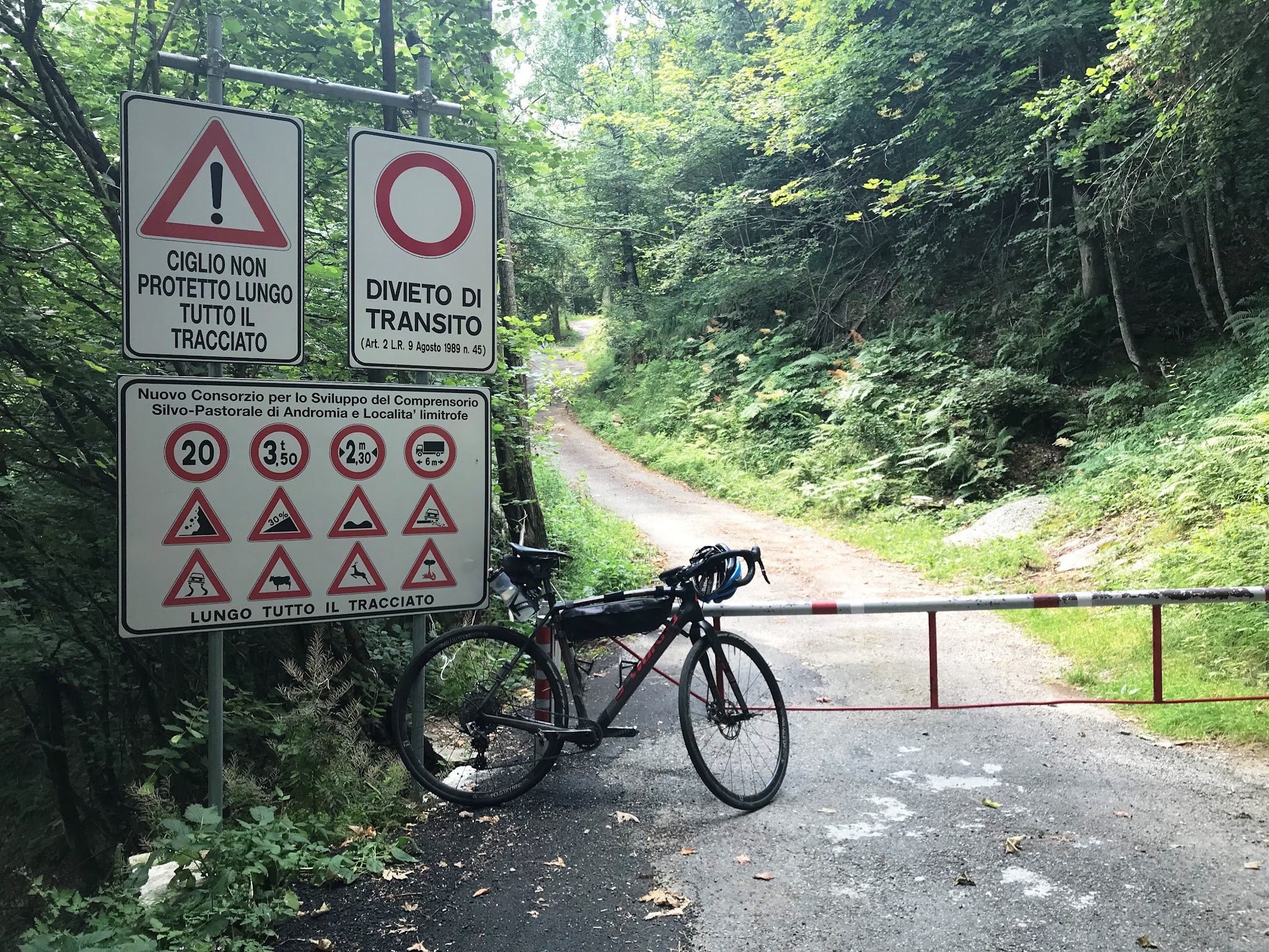 Cycling Alpe Fuori, Italy  one of the steepest bike climbs in Italy - bike and road sign. 