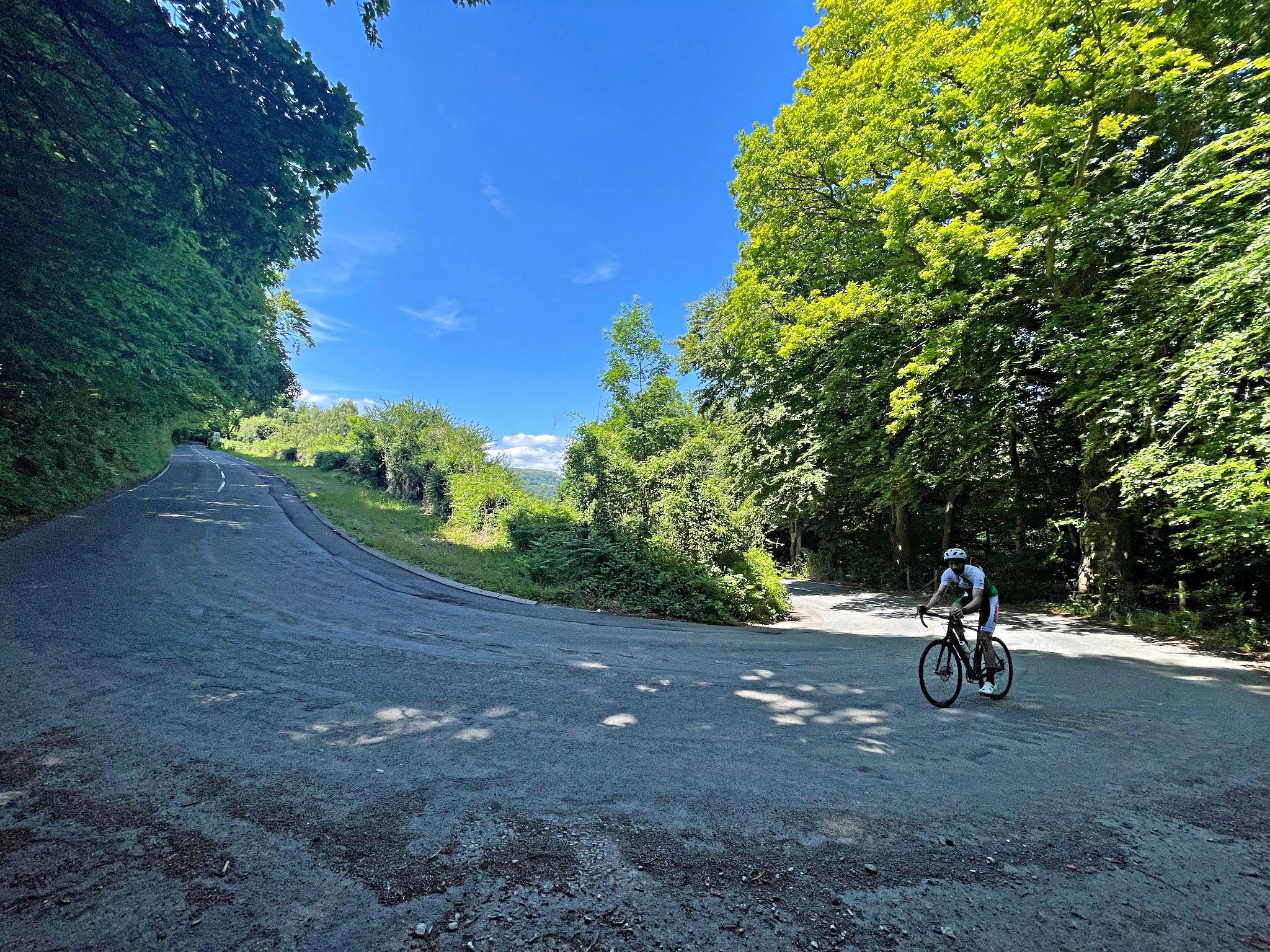 PJAMM Cyclist makes turn on hairpin turn in roadway