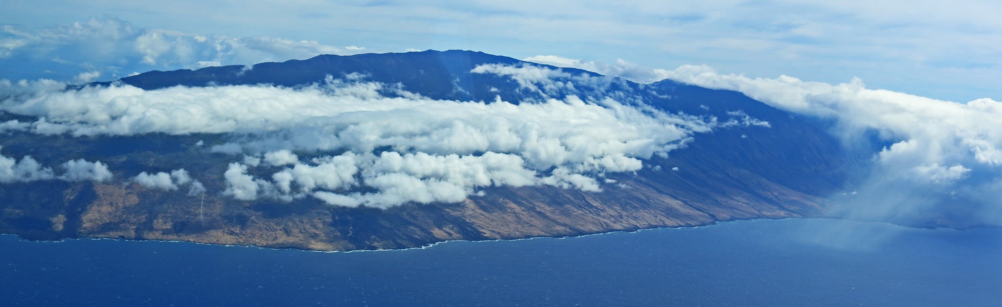 Cycling Haleakala Volcano - crater, clouds and blue sky