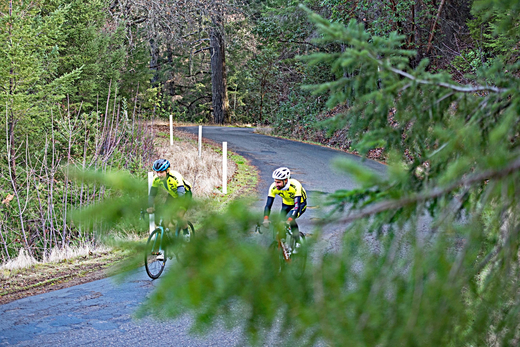 Cyclists riding bike up hill