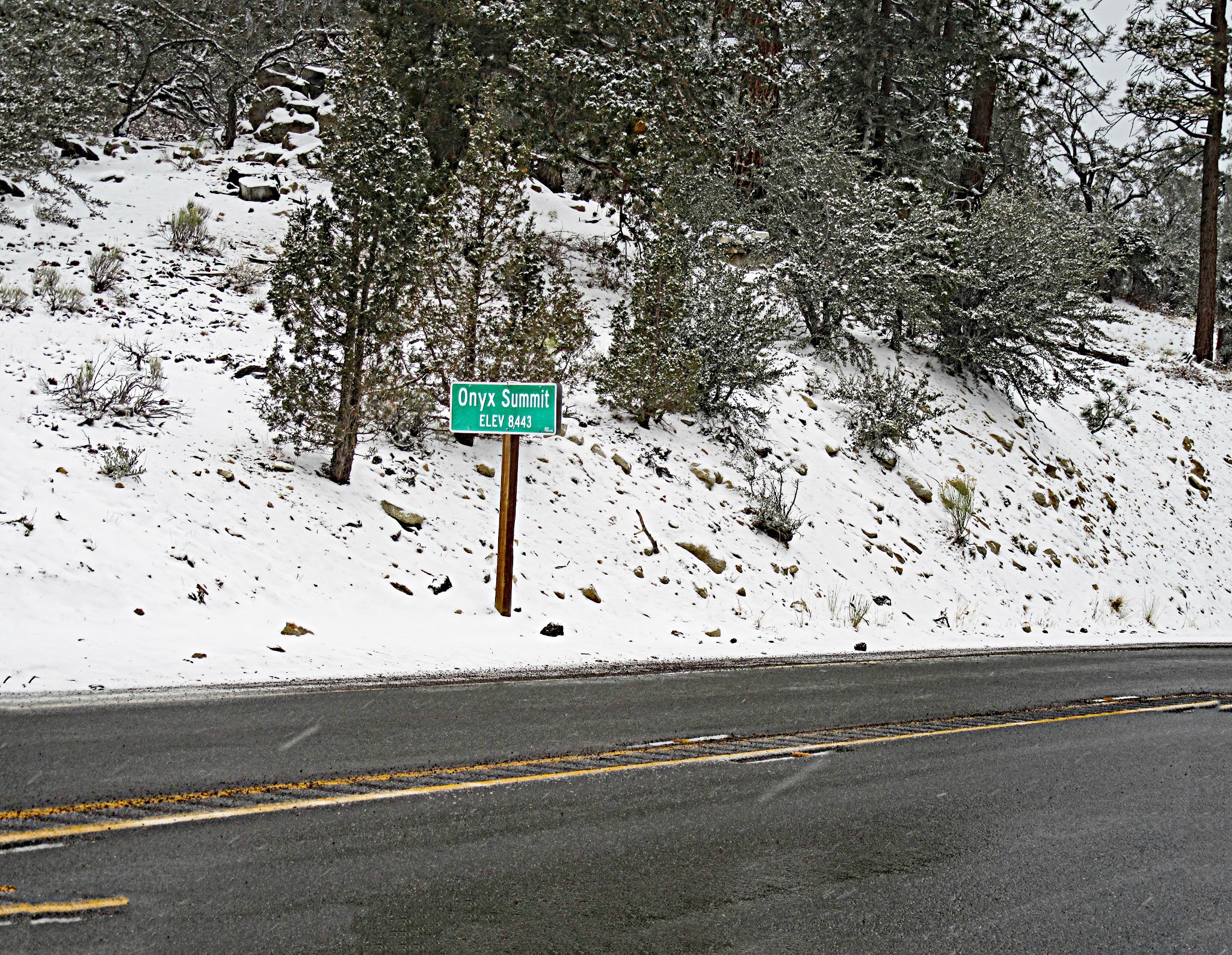 Onyx Summit bike ride - summit sign, snow
