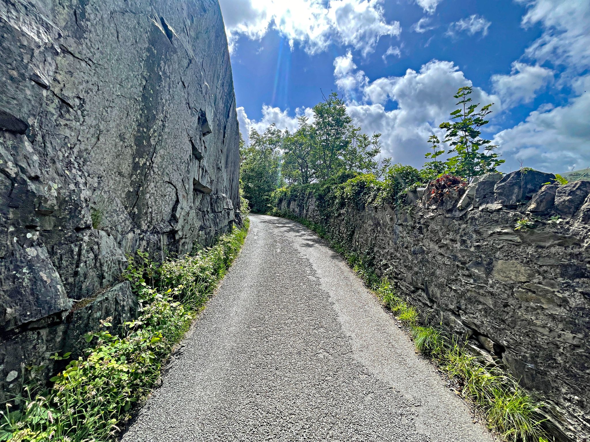 extremely narrow, one-lane roadway surrounded by rock formations on both sides