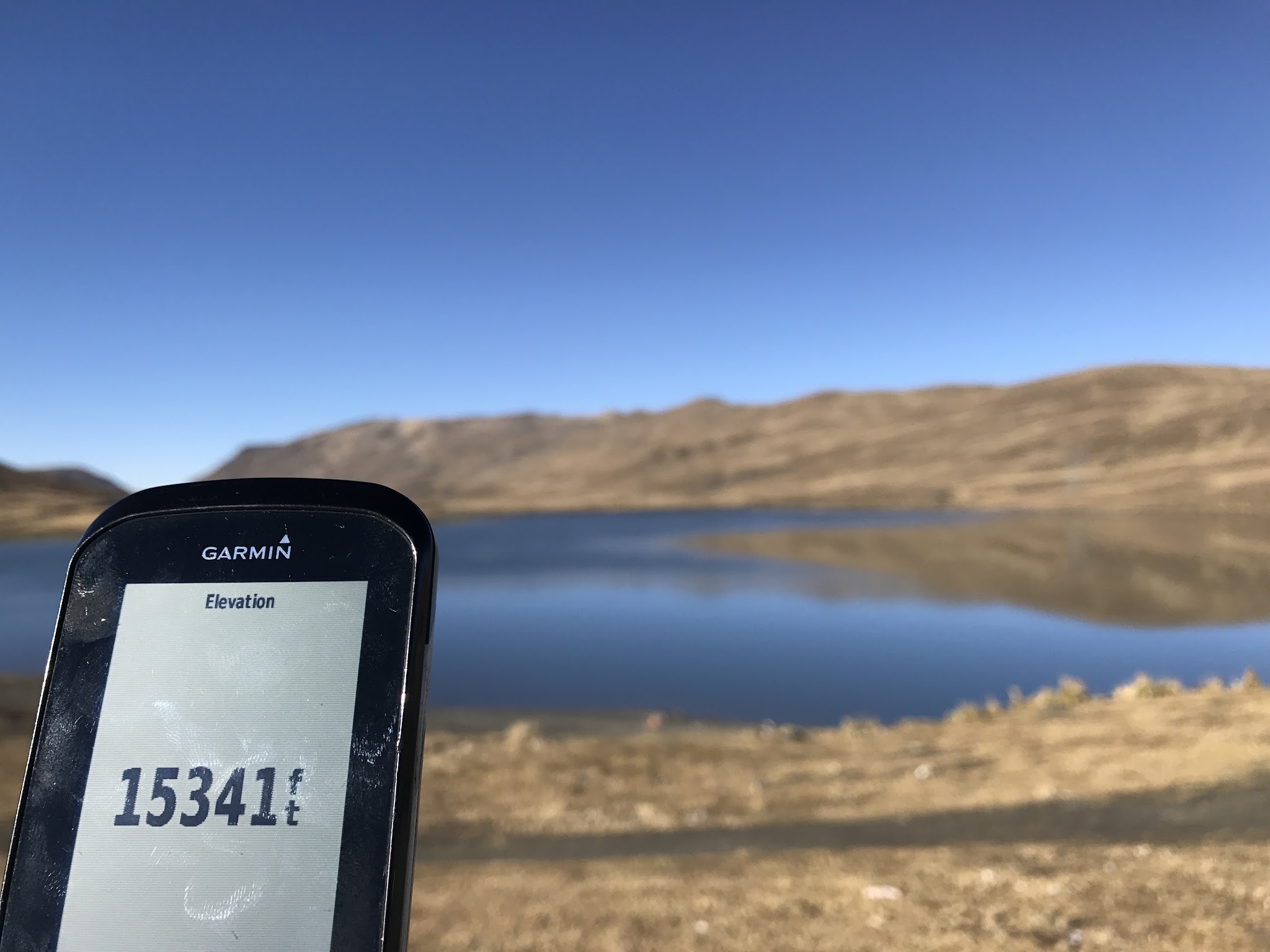 Garmin Edge 1000 showing altitude at La Cumbre Peak with Laguna Estrellani in background