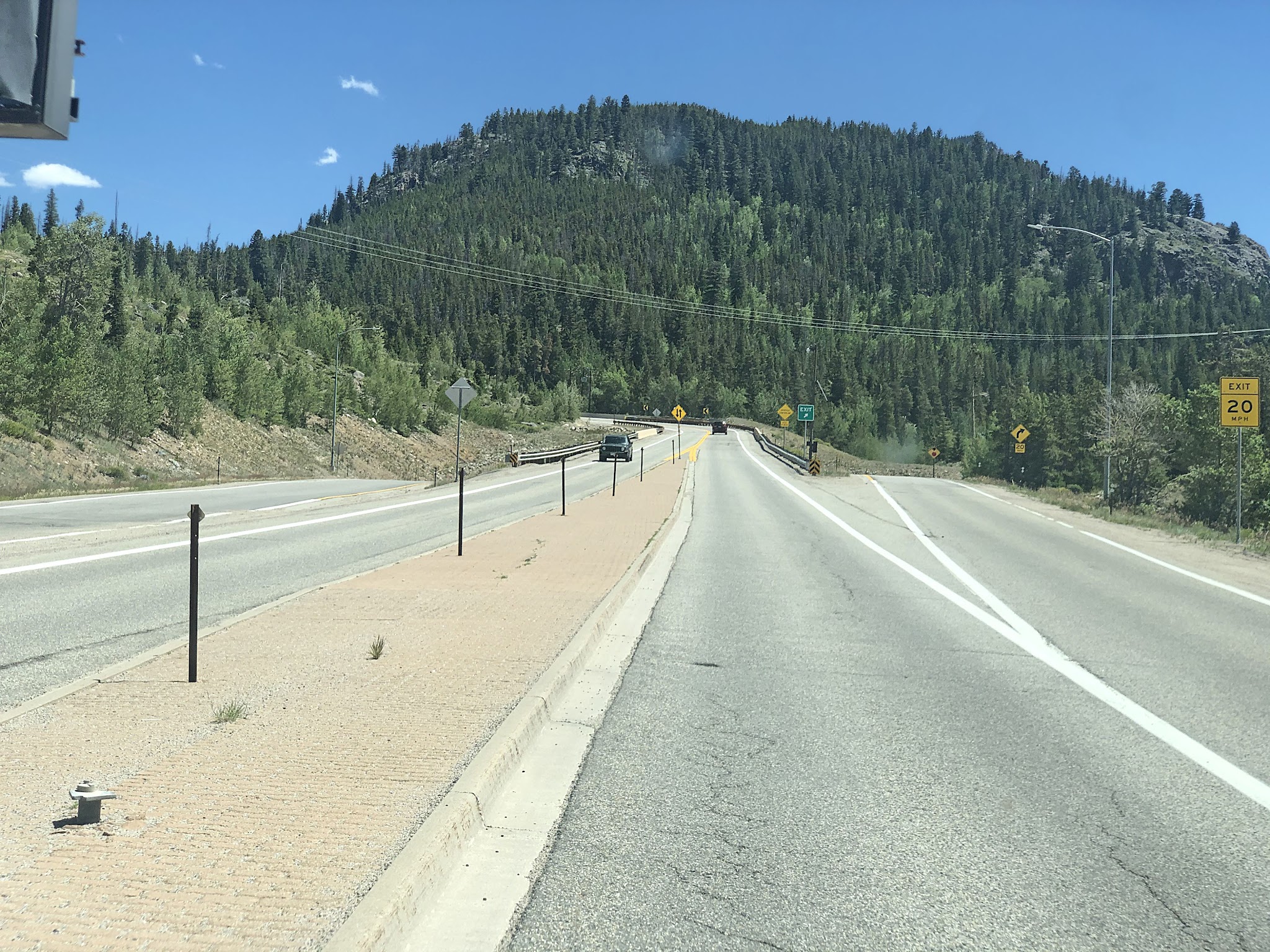 Cycling Loveland Pass South - both sides of Highway 6, going towards forested mountainside