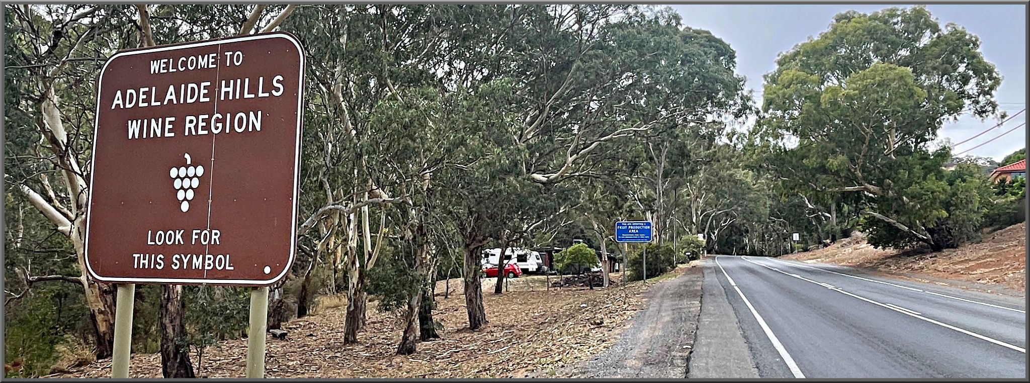 Cycling Old Norton Summit, Adelaide, Australia roadside sign reads "Welcome to Adelaide Hills Wine Region"