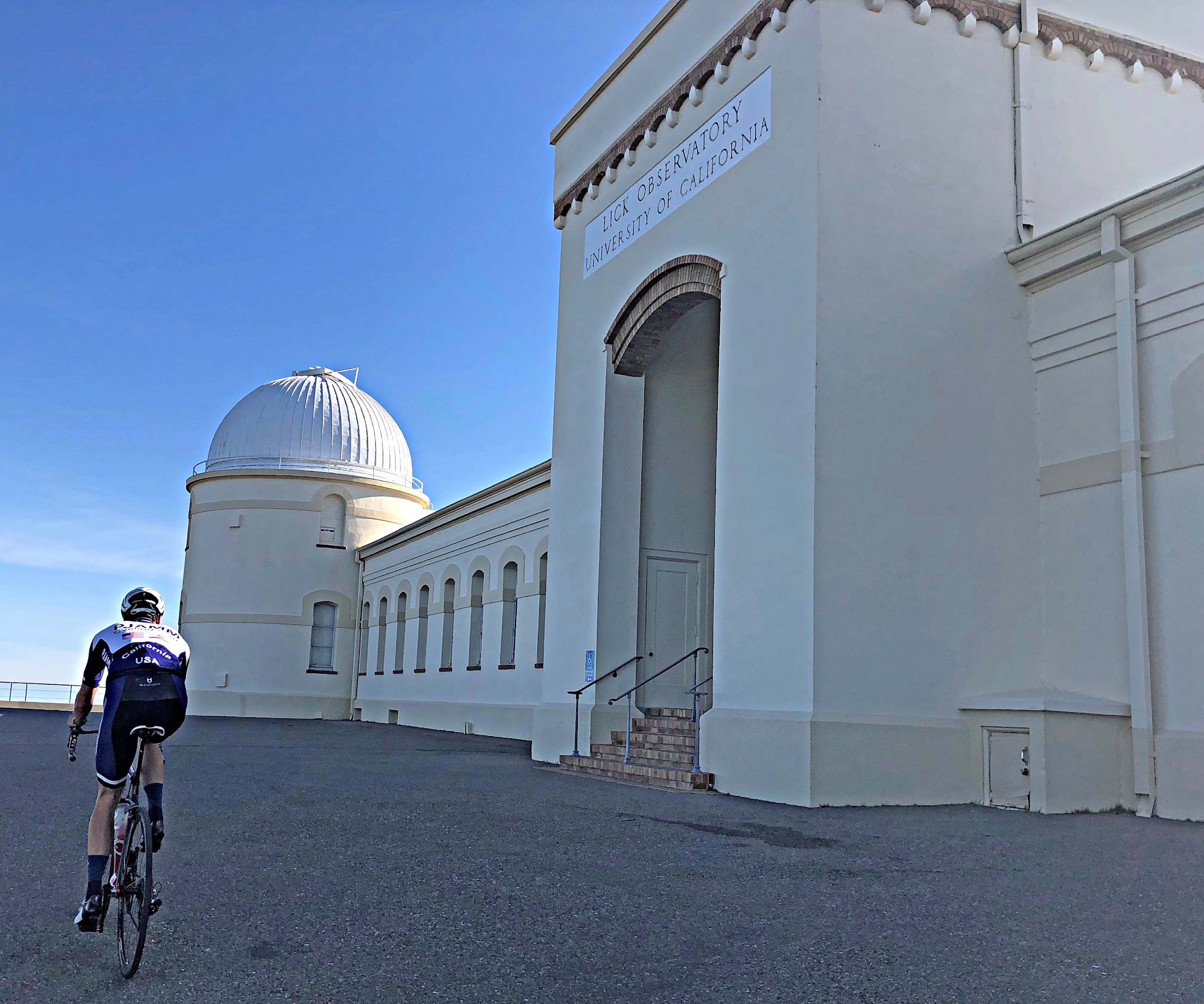 Mt. Hamilton - Lick Observatory Biking Mt. Hamilton West - Lick Observatory entrance. Cyclist riding past front of Lick Observatory.