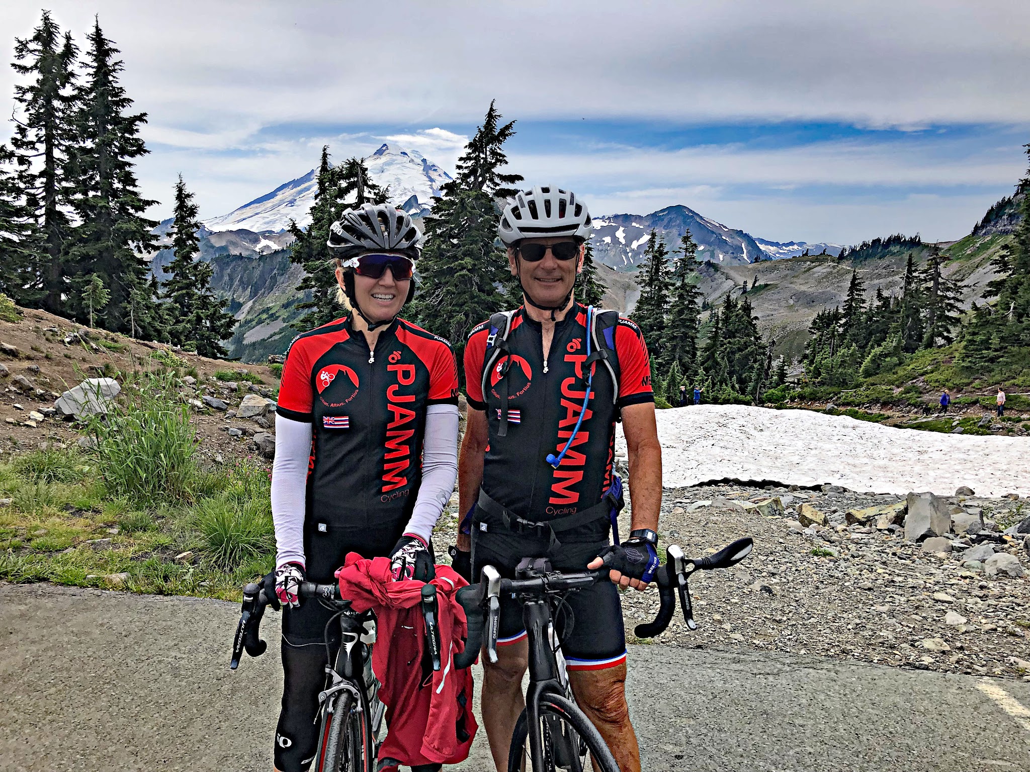 Biking Mt. Baker - Stacy Topping and Bruce Hamilton of PJAMM with bikes at Artist Point with  Mt. Shuksan in background