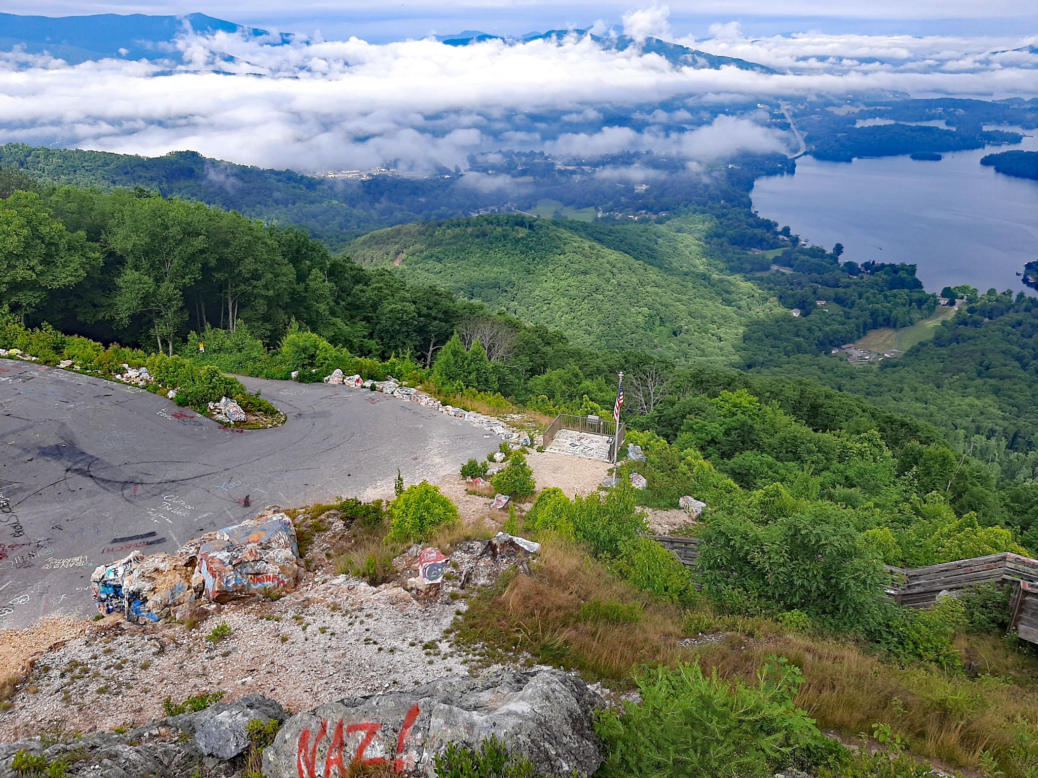 view looking down from mountain top at extremely steep grade up roadway