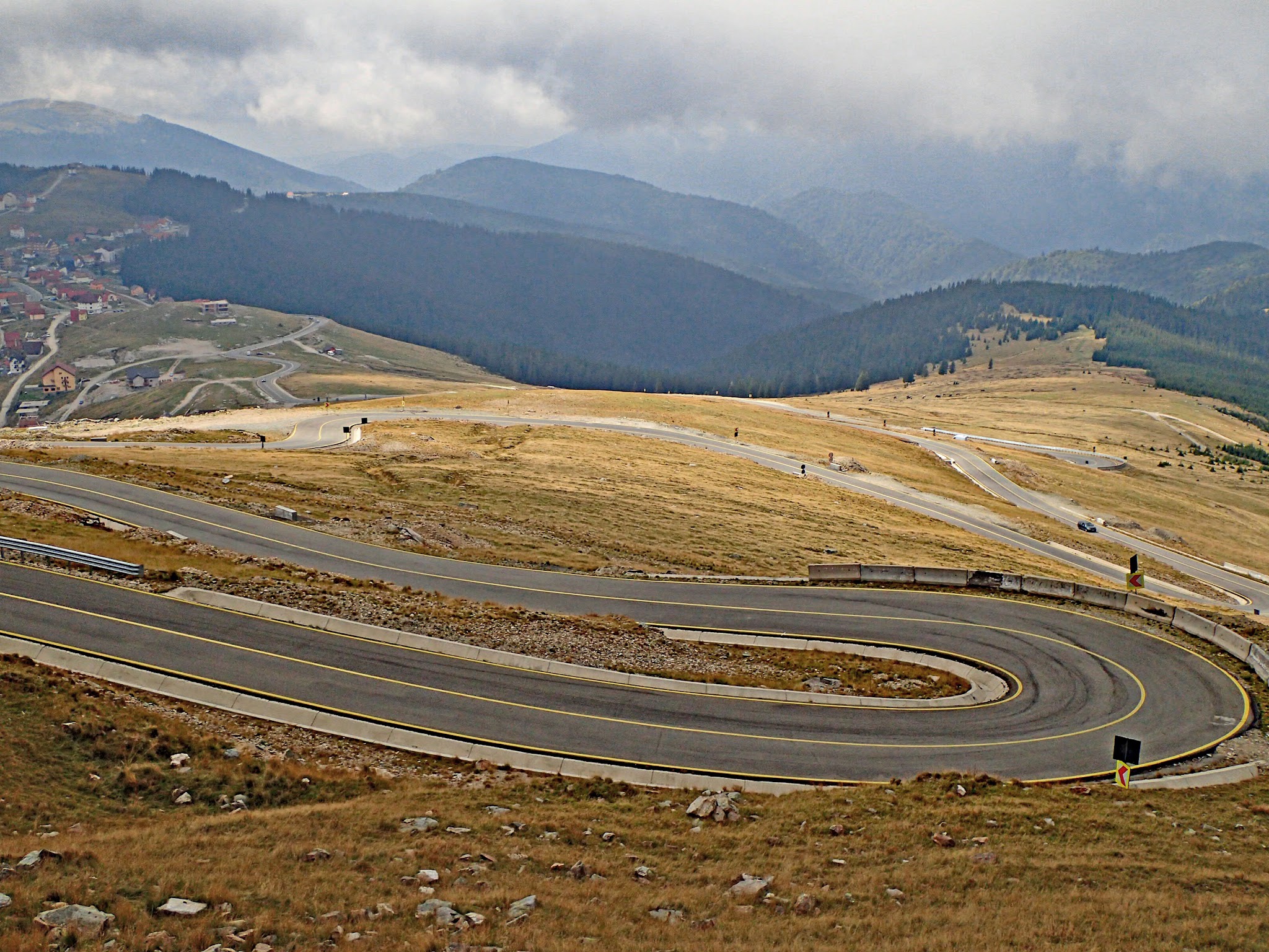 Cycling Transalpina North, Romania - deep "u" shaped roadway, switchbacking up mountainside