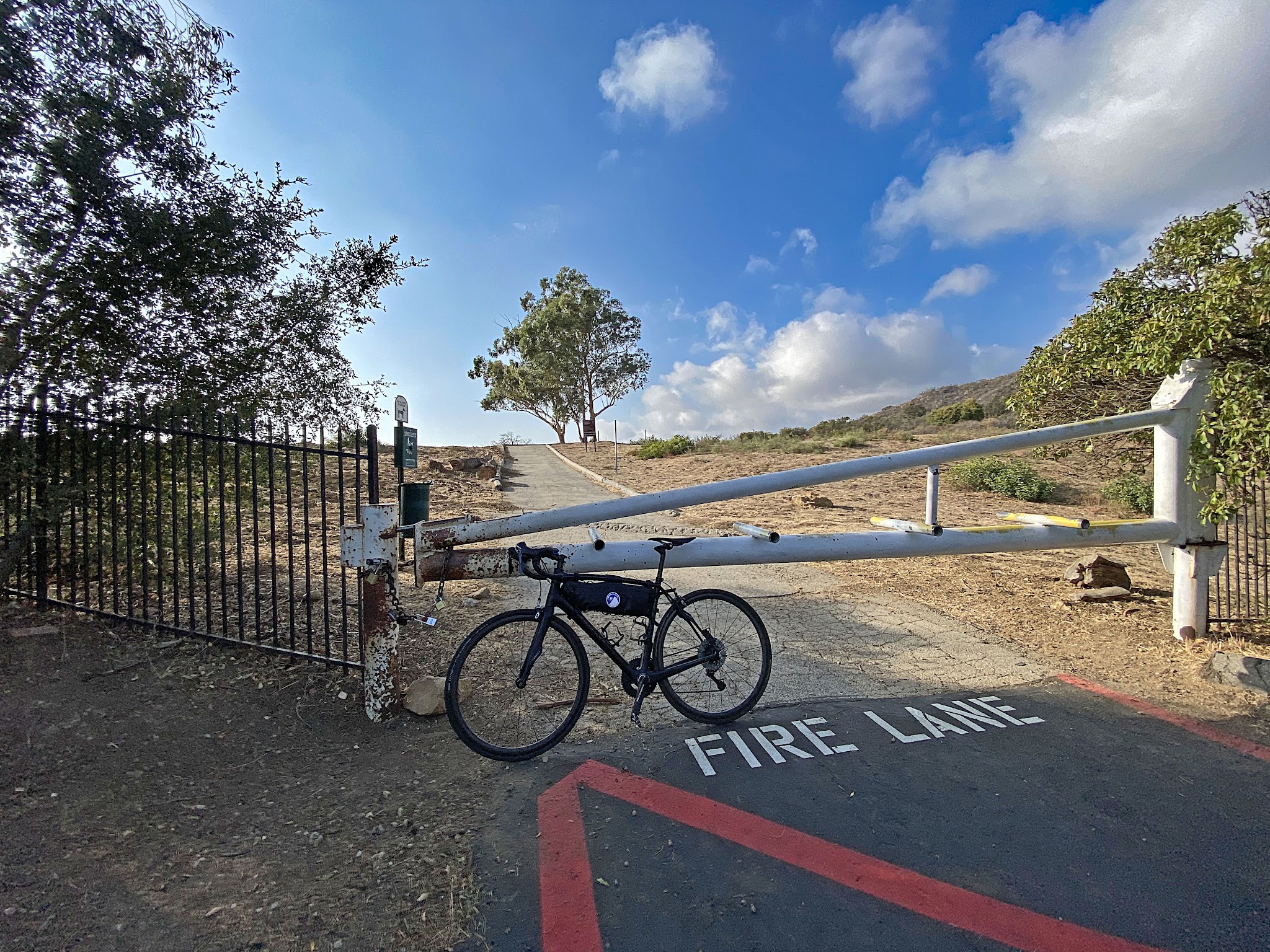Cycling Big Rock Drive to Stunt Road - bike parked against closed gate on fire road