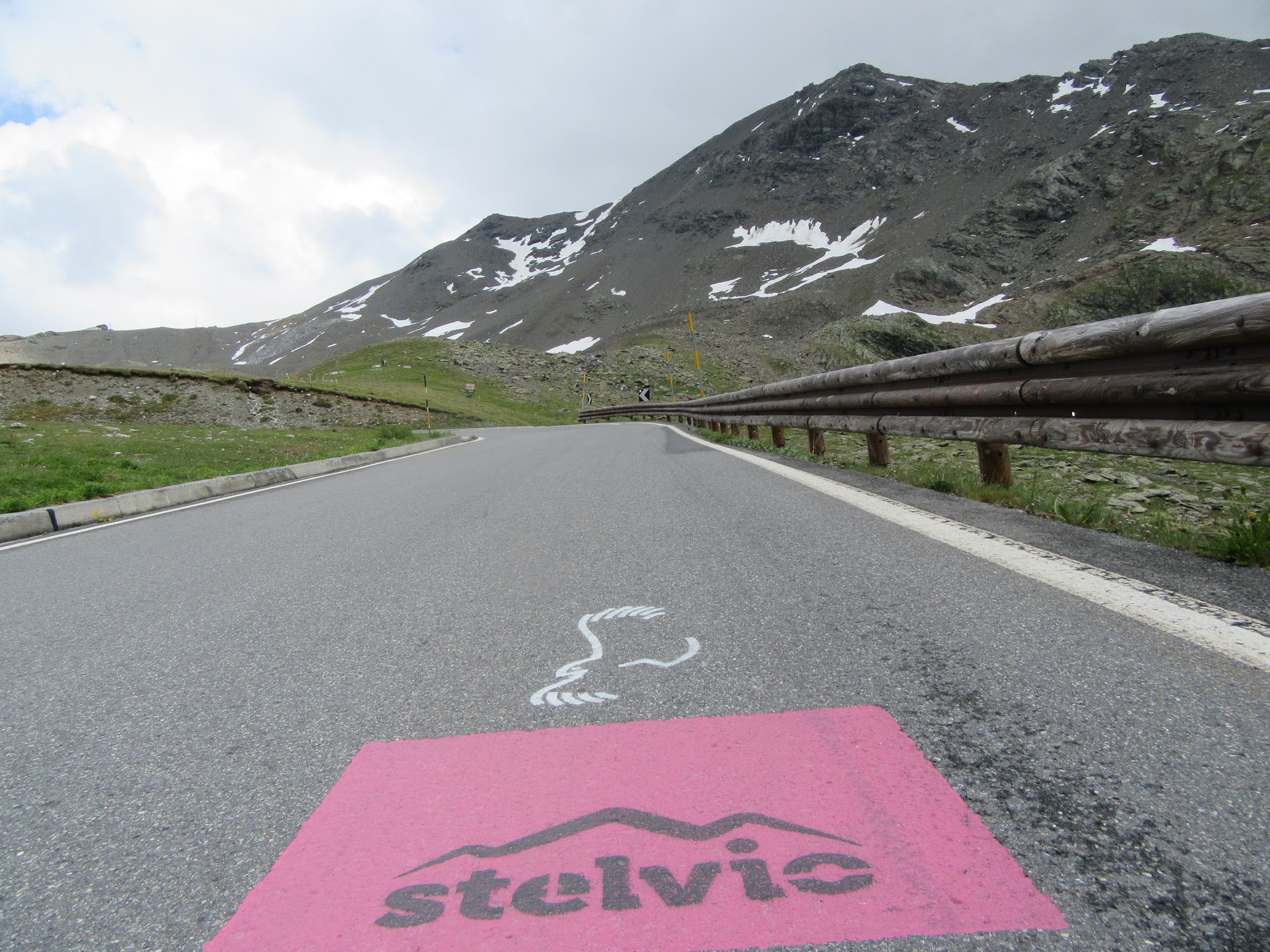 Riding bike to Umbrail Pass and Stelvio - pink stelvio sign on road