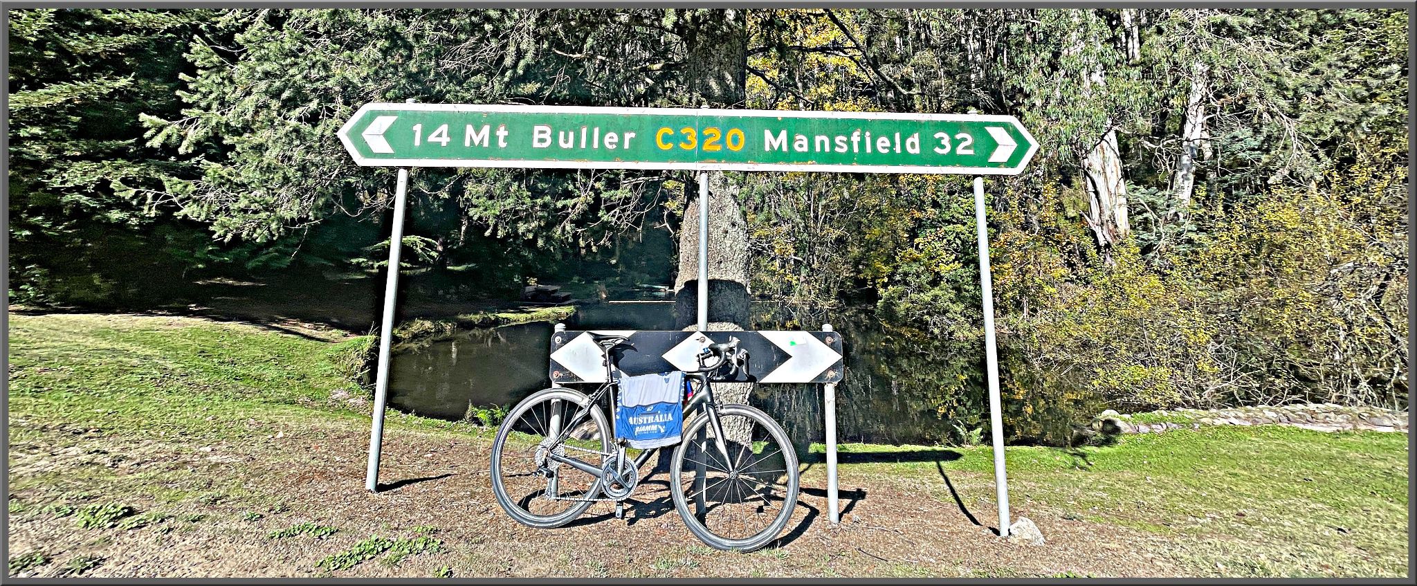 bike parked in front of road sign for Mt Buller and Mansfield