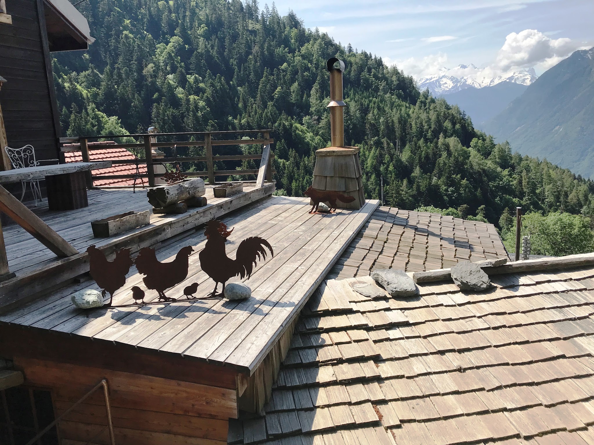 Climbing Rionda by bike - rooster weather vane on rooftop