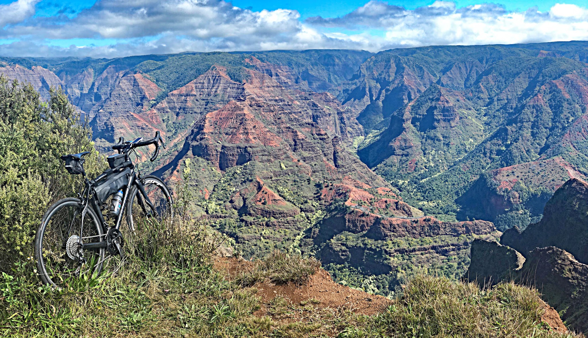 bike parked on roadside at mile 10.8 on Waimea Canyon ride, looking out over beautiful canyon views