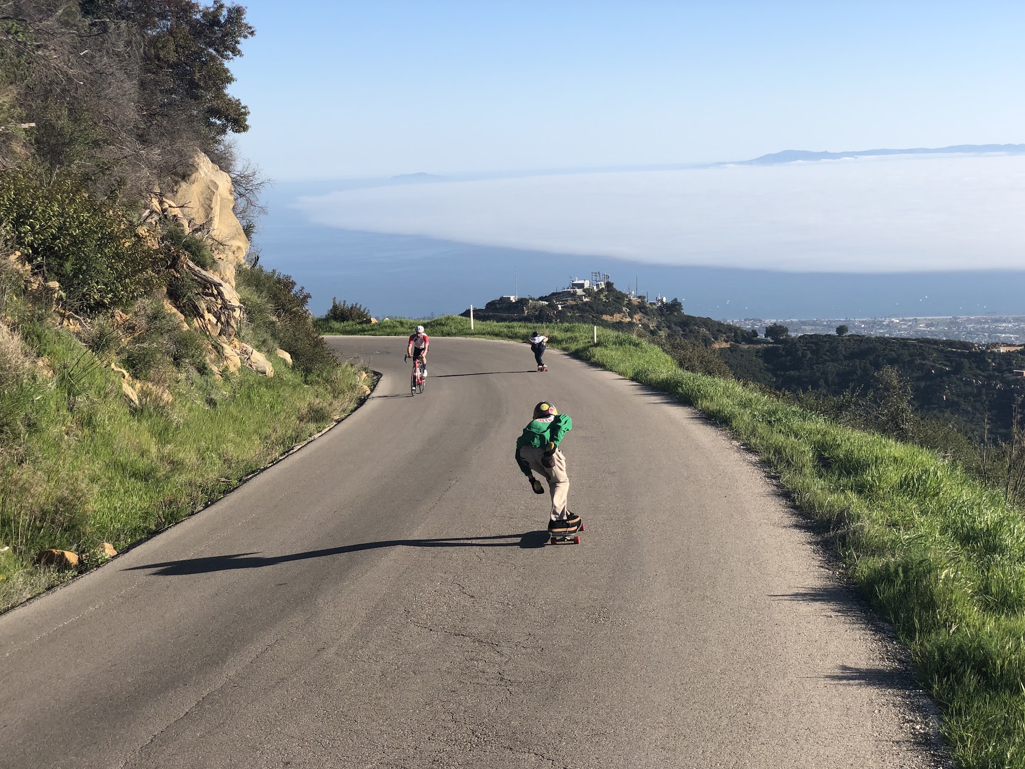 Bicycle ride and climb Gibraltar Road - skateboarders passing cyclist - road, Santa Barbara and Pacific Ocean