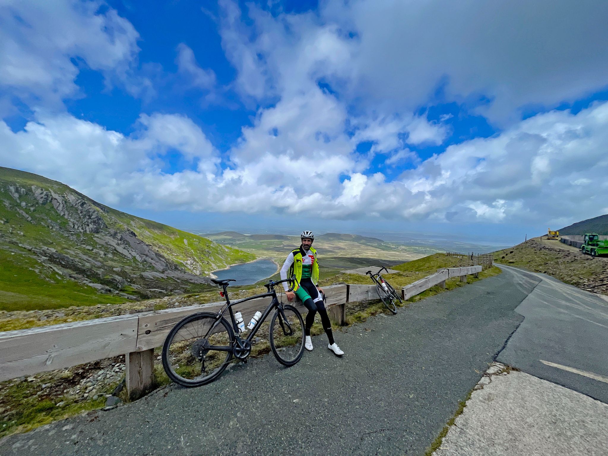 PJAMM Cyclist stands next to bike at climb finish