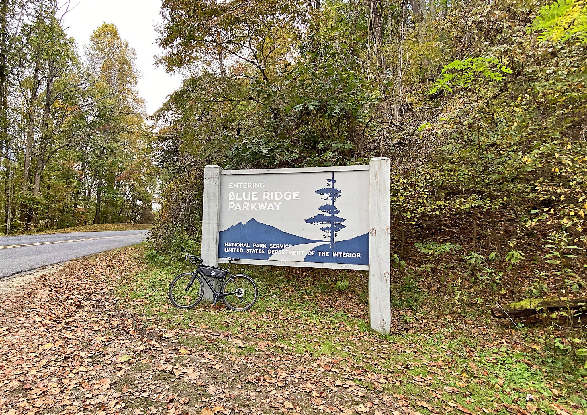 Cycling Clingmans Dome, North Carolina - bike parked in front of large sign for Blue Ridge Parkway