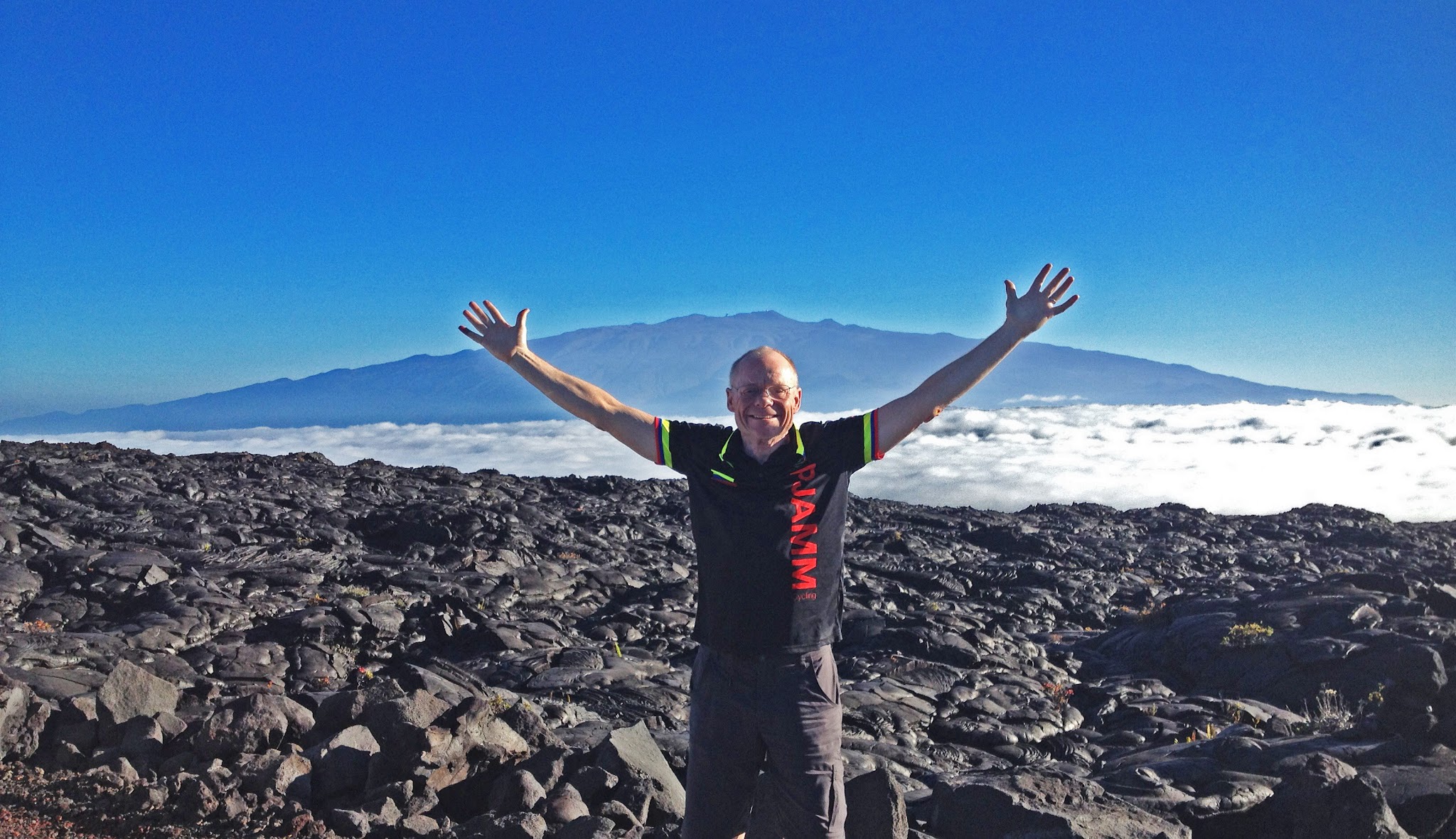 cycling Top 10 US Bike Climbs - Mauna Kea cyclist coming above the clouds